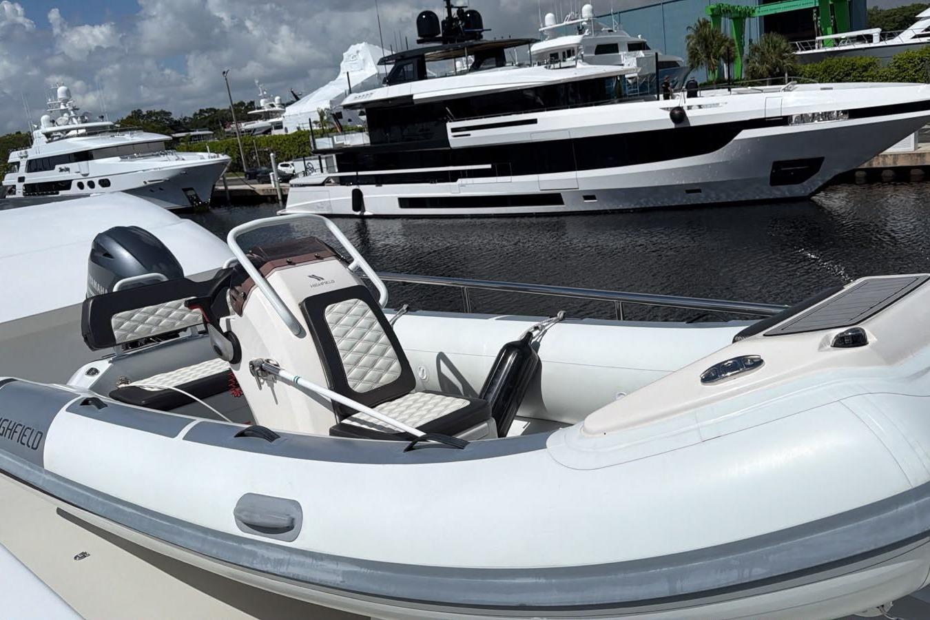 2022 Highfield Sport 420 boat docked, featuring sleek design and luxurious seating.