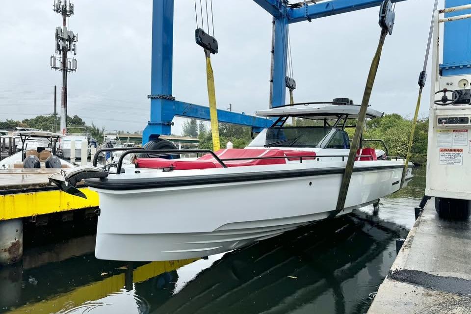 2023 BRABUS Shadow 900 ST boat being lifted by crane at marina.