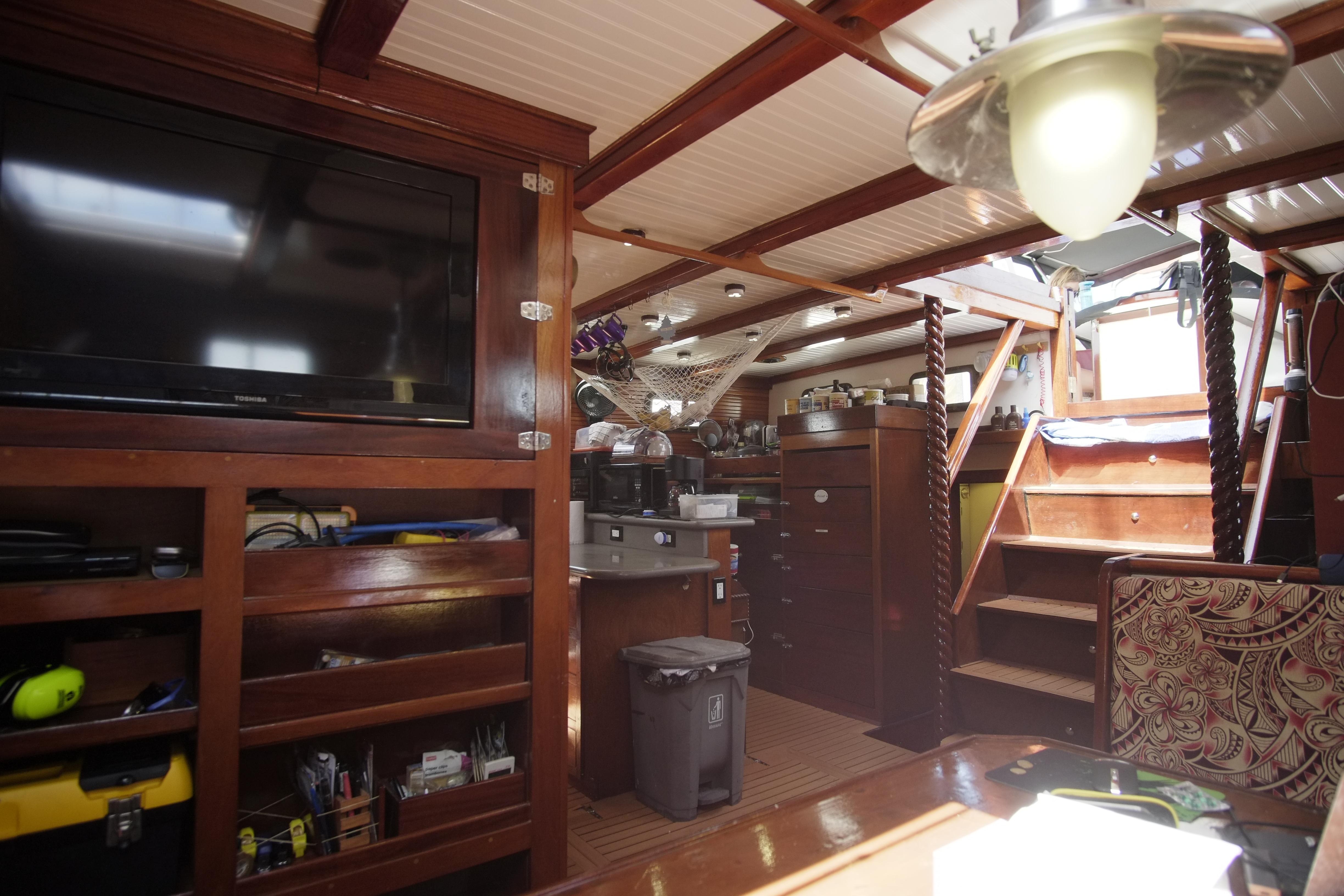 Interior of 2006 Custom Bud Macintosh schooner with wooden cabinetry and modern amenities.