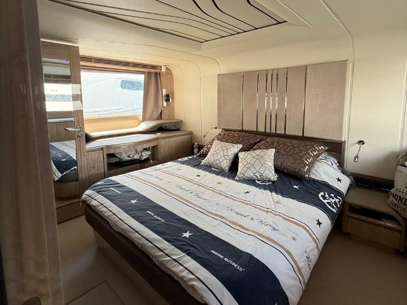 Luxurious bedroom interior of 2021 Galeon 700 Sky yacht with elegant bedding and modern design.