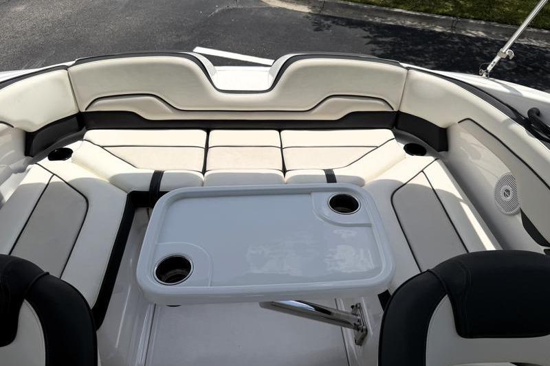 2017 Yamaha Boats SX210 interior with seating and table, featuring cup holders.