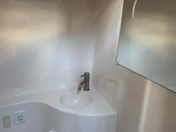 A modern bathroom with a sink and mirror.
