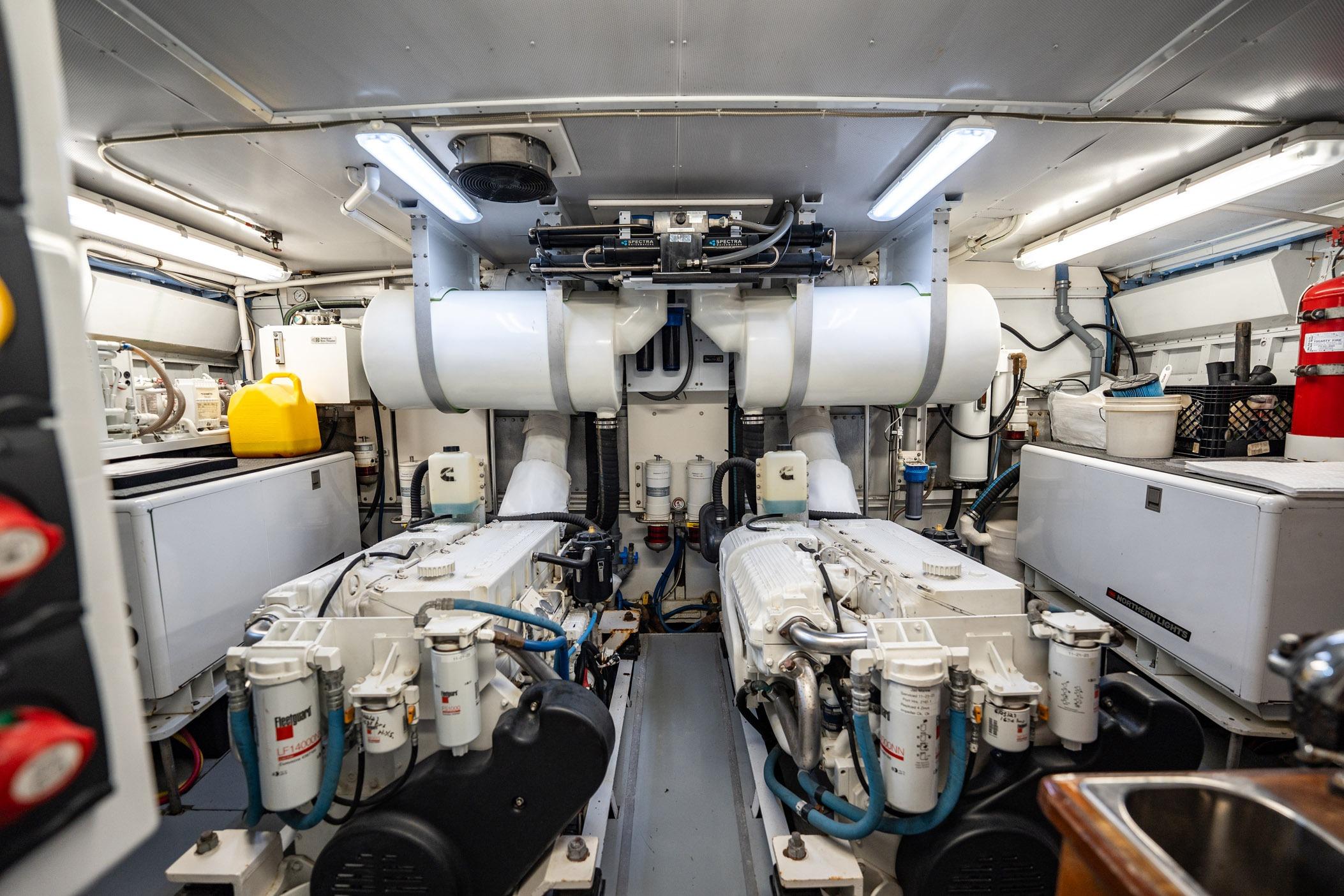 Engine room of a 1972 Trumpy 72 Motor Yacht, featuring dual engines and equipment.