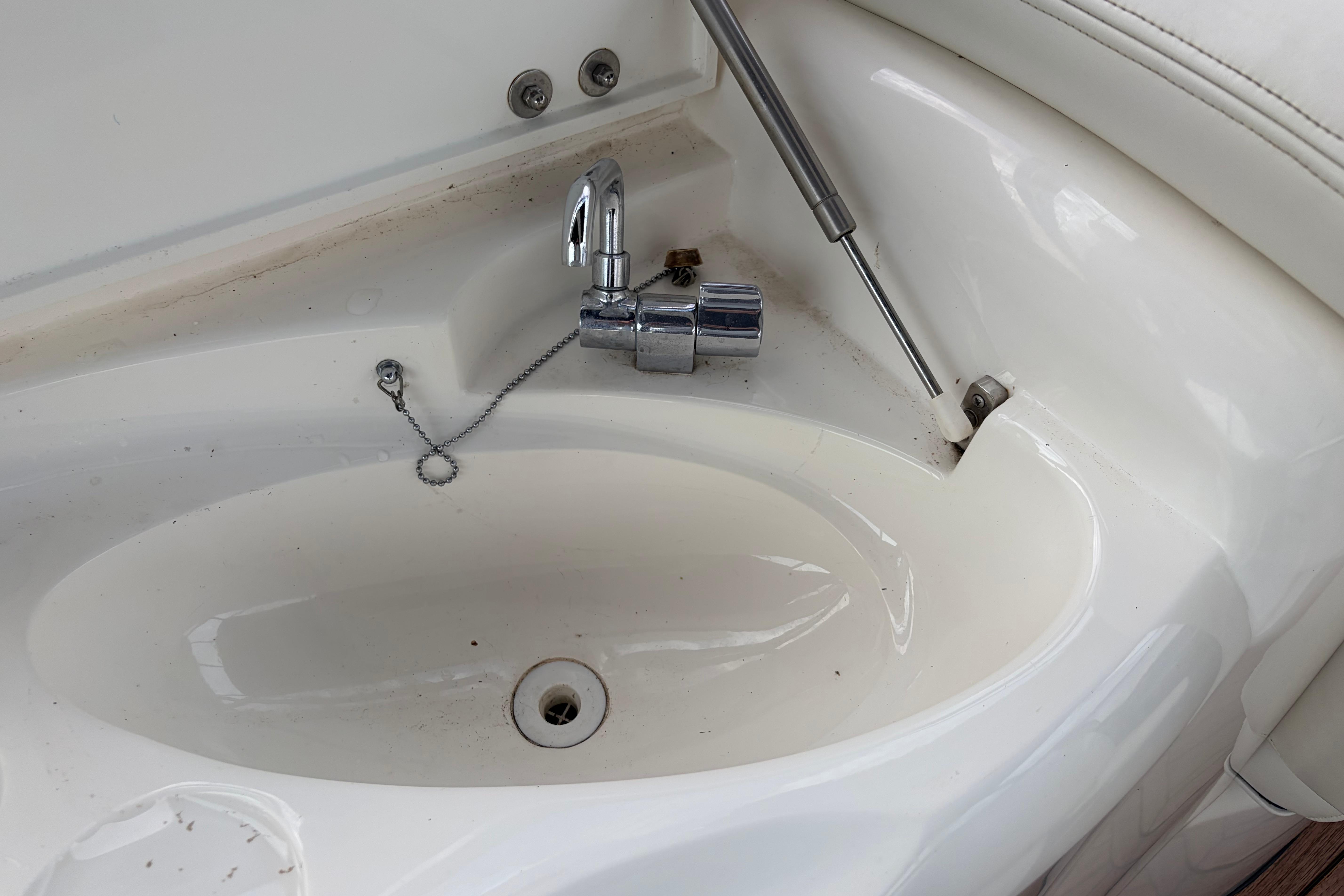 Sunseeker Superhawk 34 (2000) yacht sink with chrome faucet and hydraulic support.