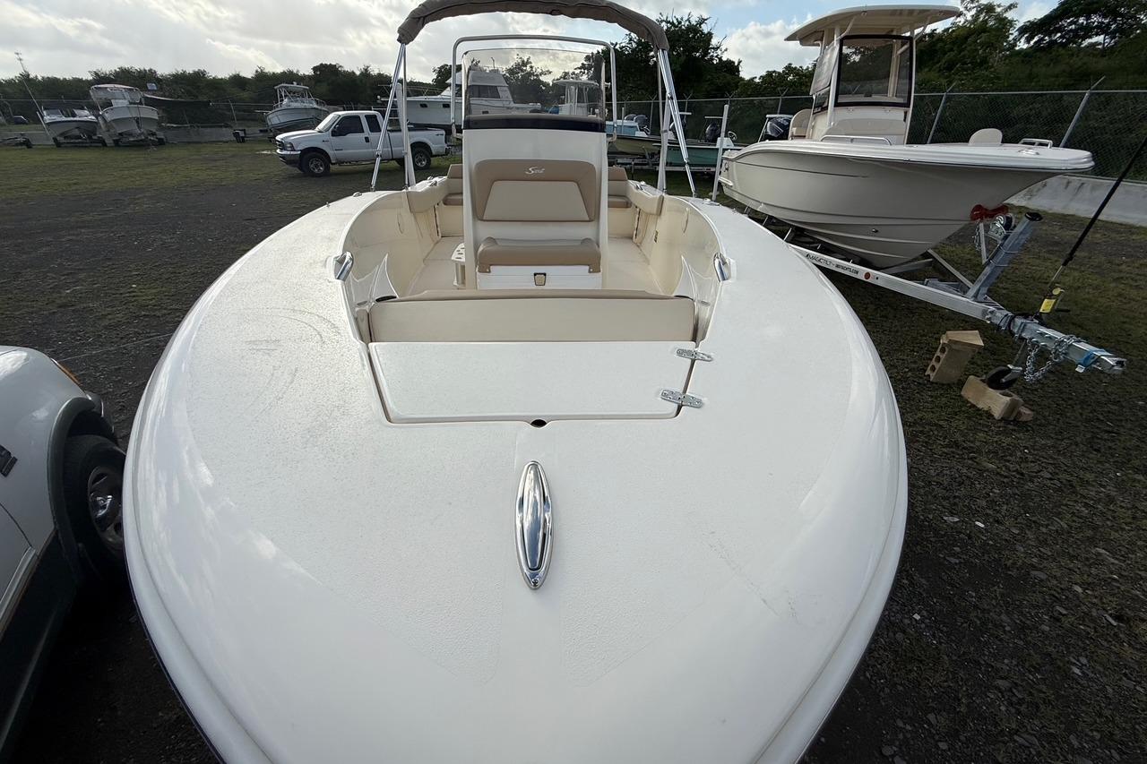 2026 Scout 195 Sportfish boat on display in outdoor setting.