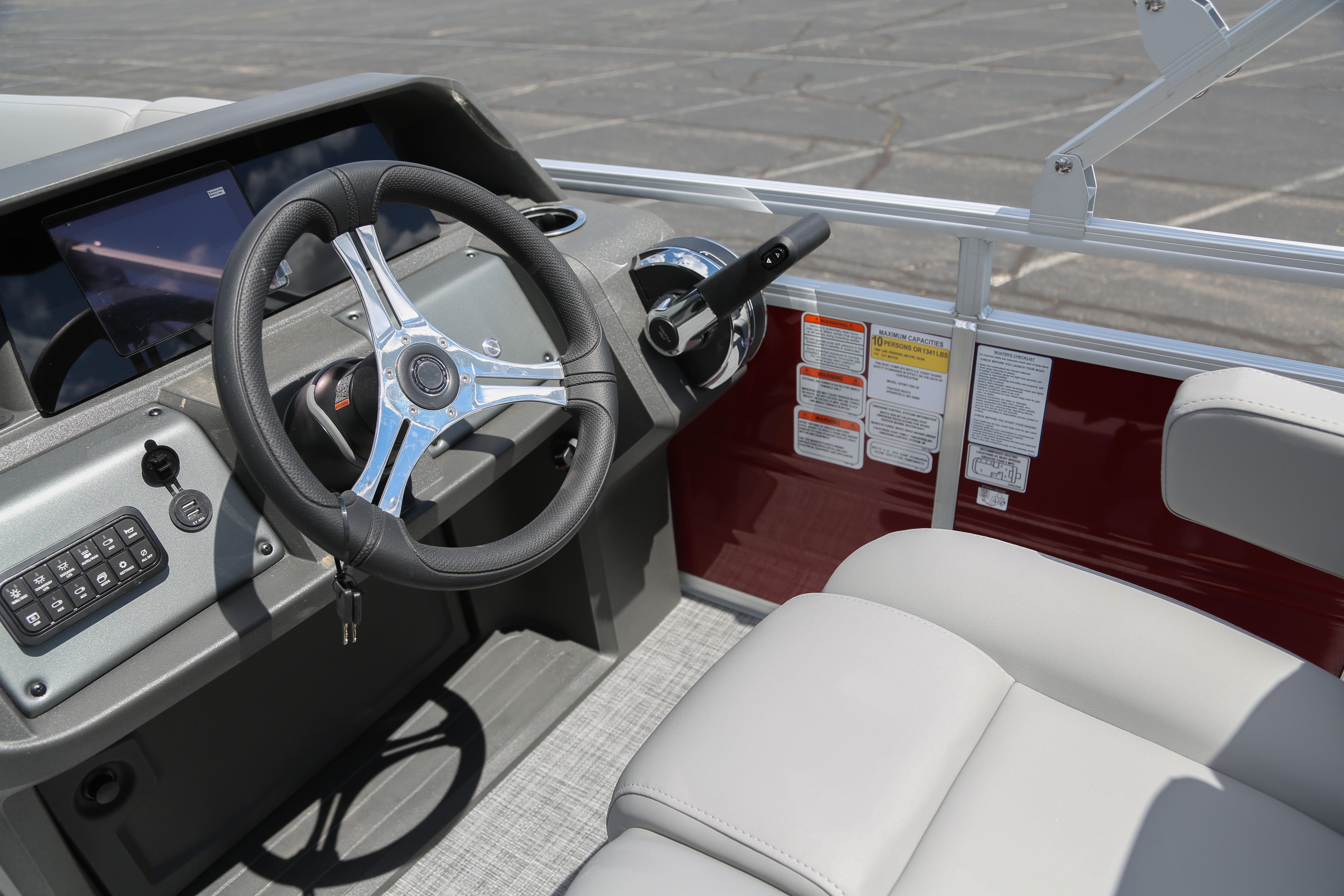2026 Sun Tracker SportFish 20 DLX boat interior with steering wheel and control panel.