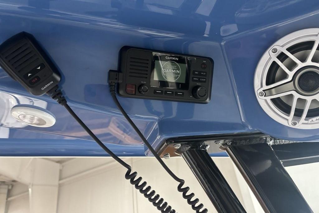 2026 Sportsman Masters 247 Bay Boat dashboard with Garmin radio and speaker system.