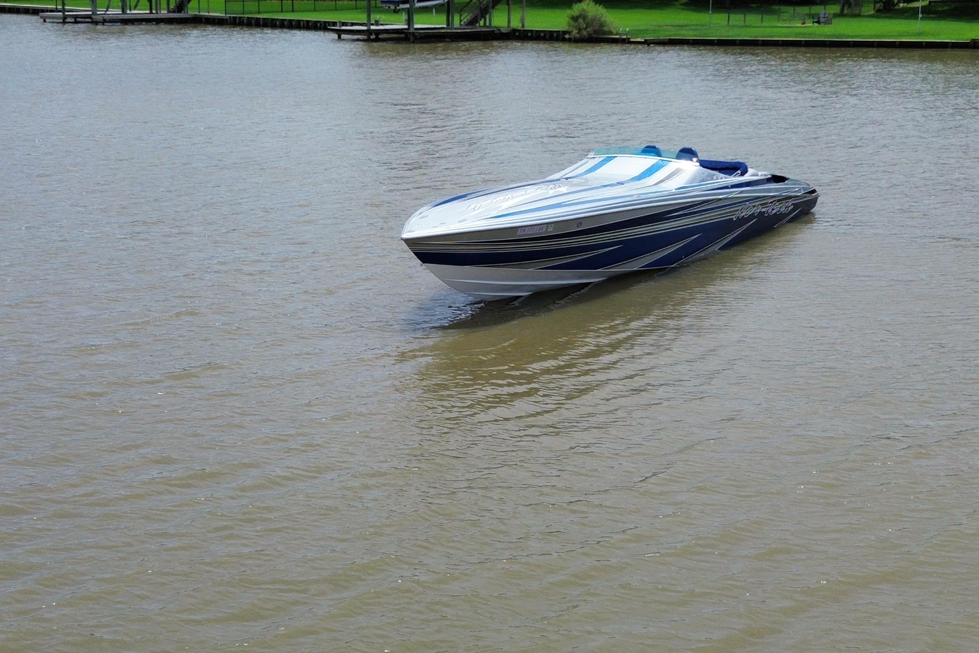 2013 Nor-Tech 477 SPX Vee Bottom boat cruising on a calm lake.