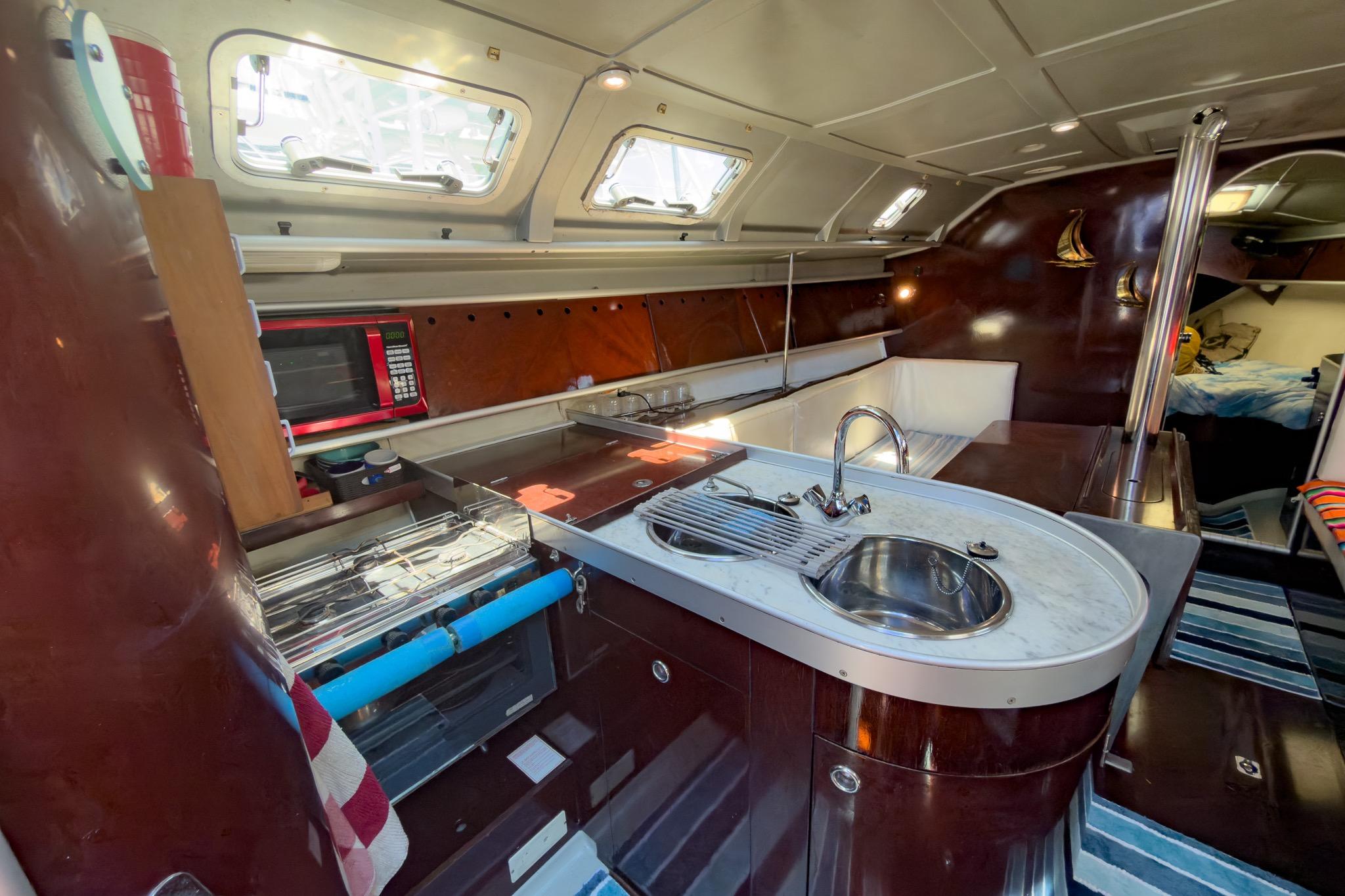 Interior of 1993 Beneteau First 38 s5 yacht with modern kitchen amenities.
