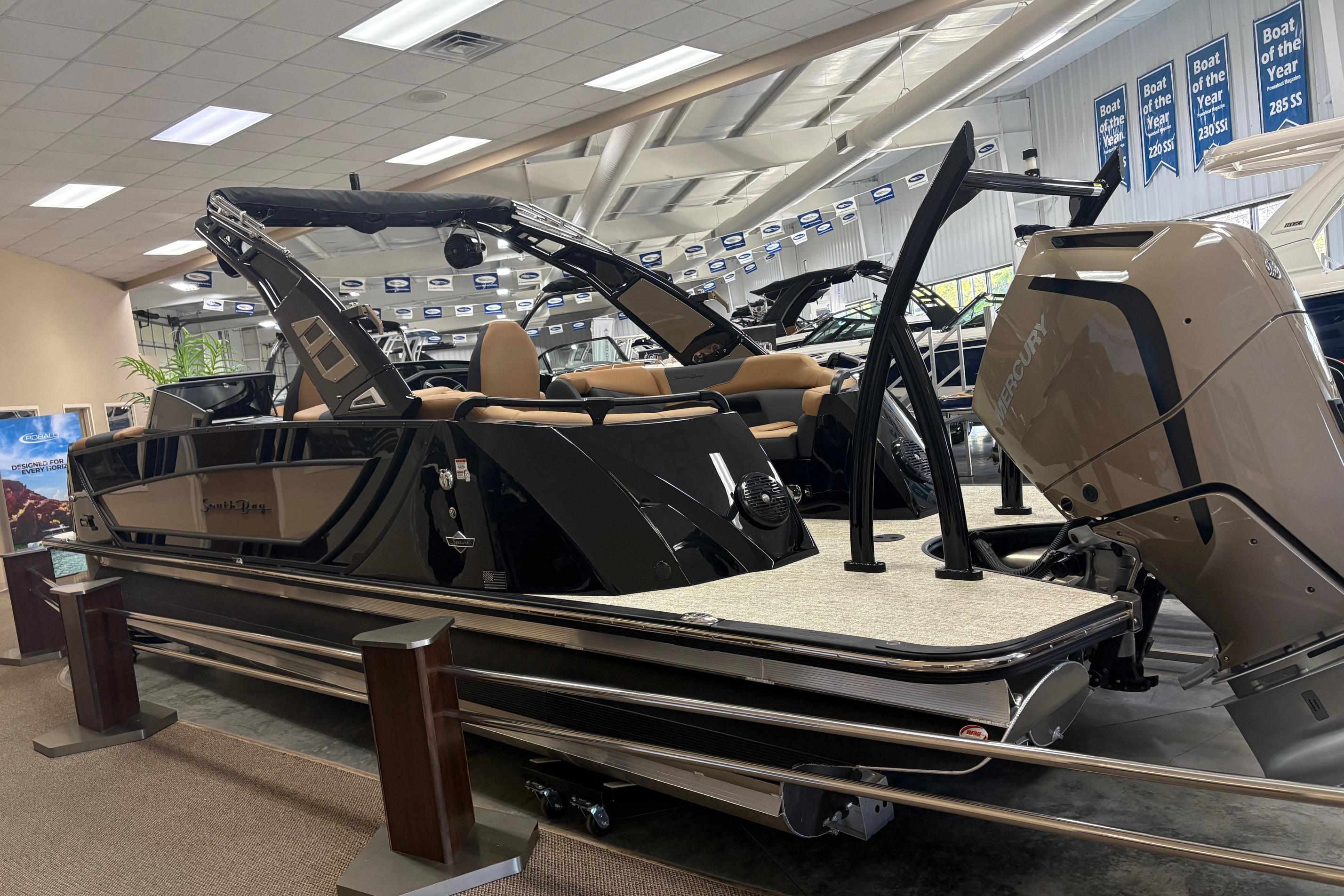 2026 South Bay Sport RS9 DC boat displayed indoors with Mercury engine.