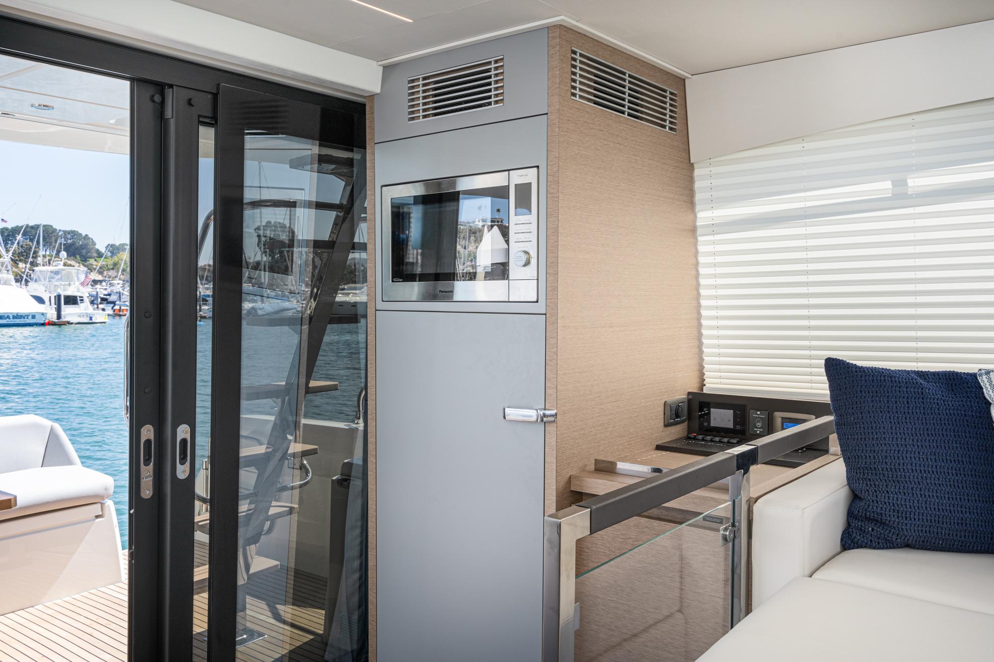 Interior of 2022 Prestige 460 yacht with modern kitchen and ocean view.