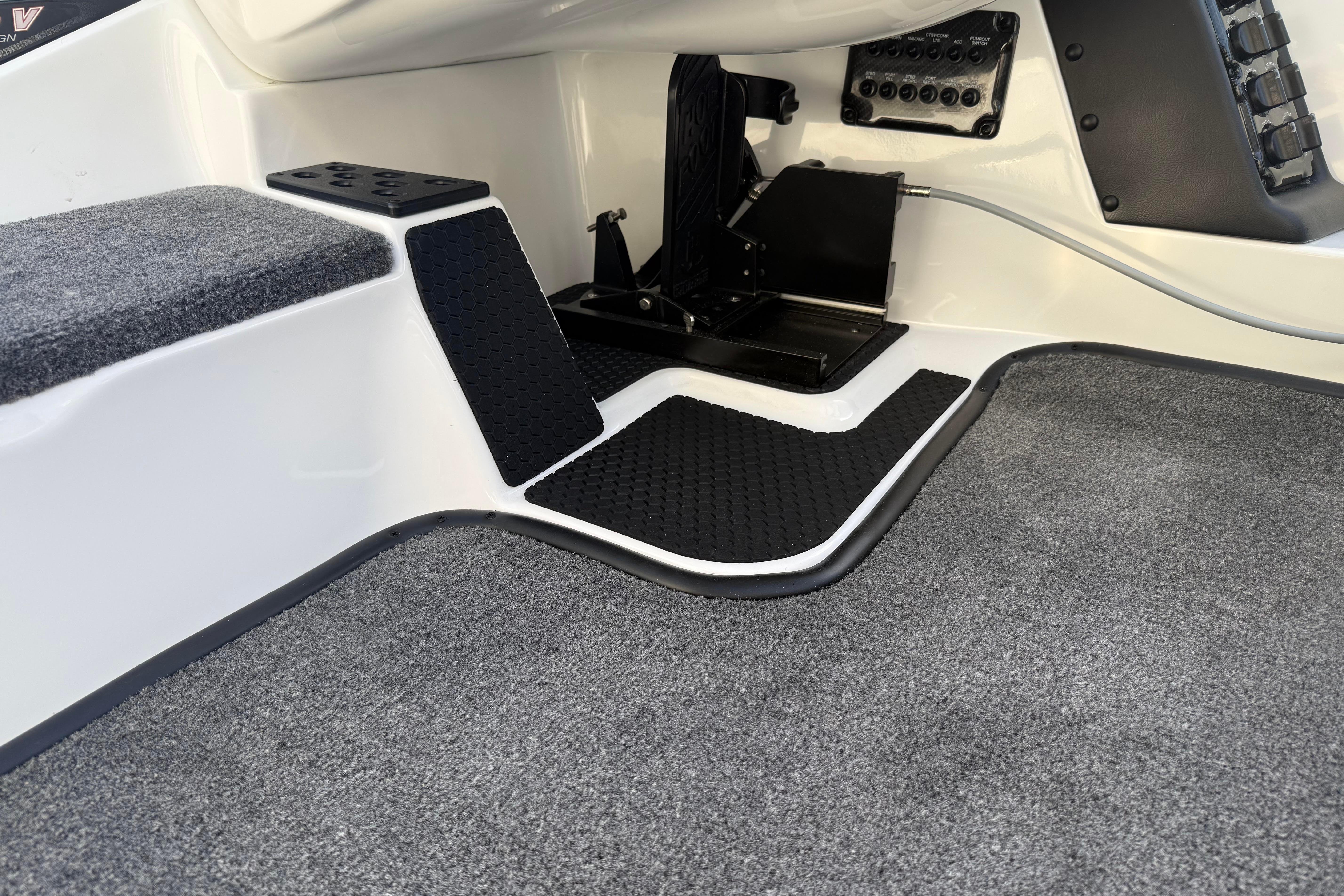 Interior of 2027 Phoenix 721 ZXL boat with carpeted flooring and control panel.