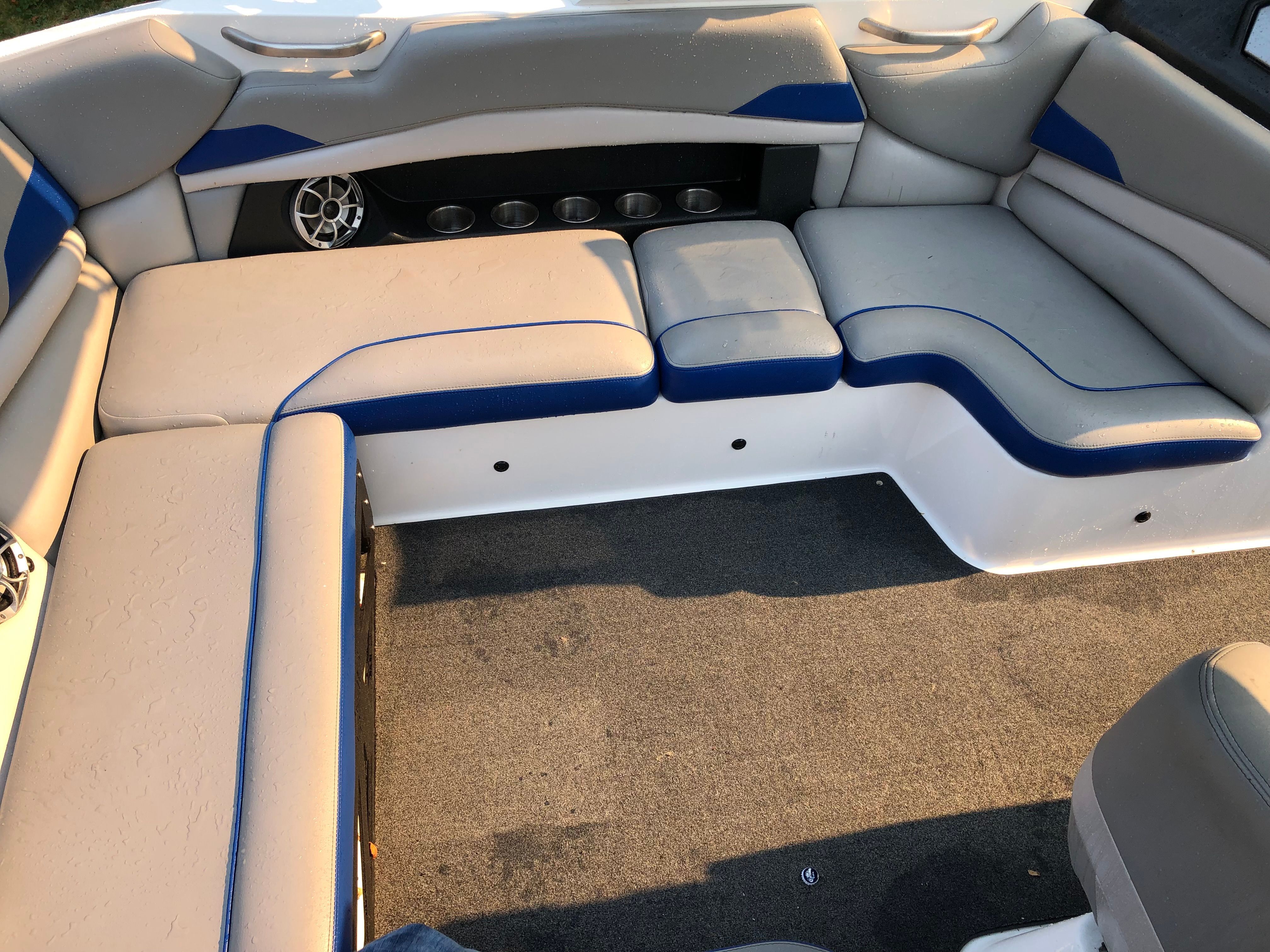 Interior of Custom a22 boat, gray and blue upholstery, speakers.