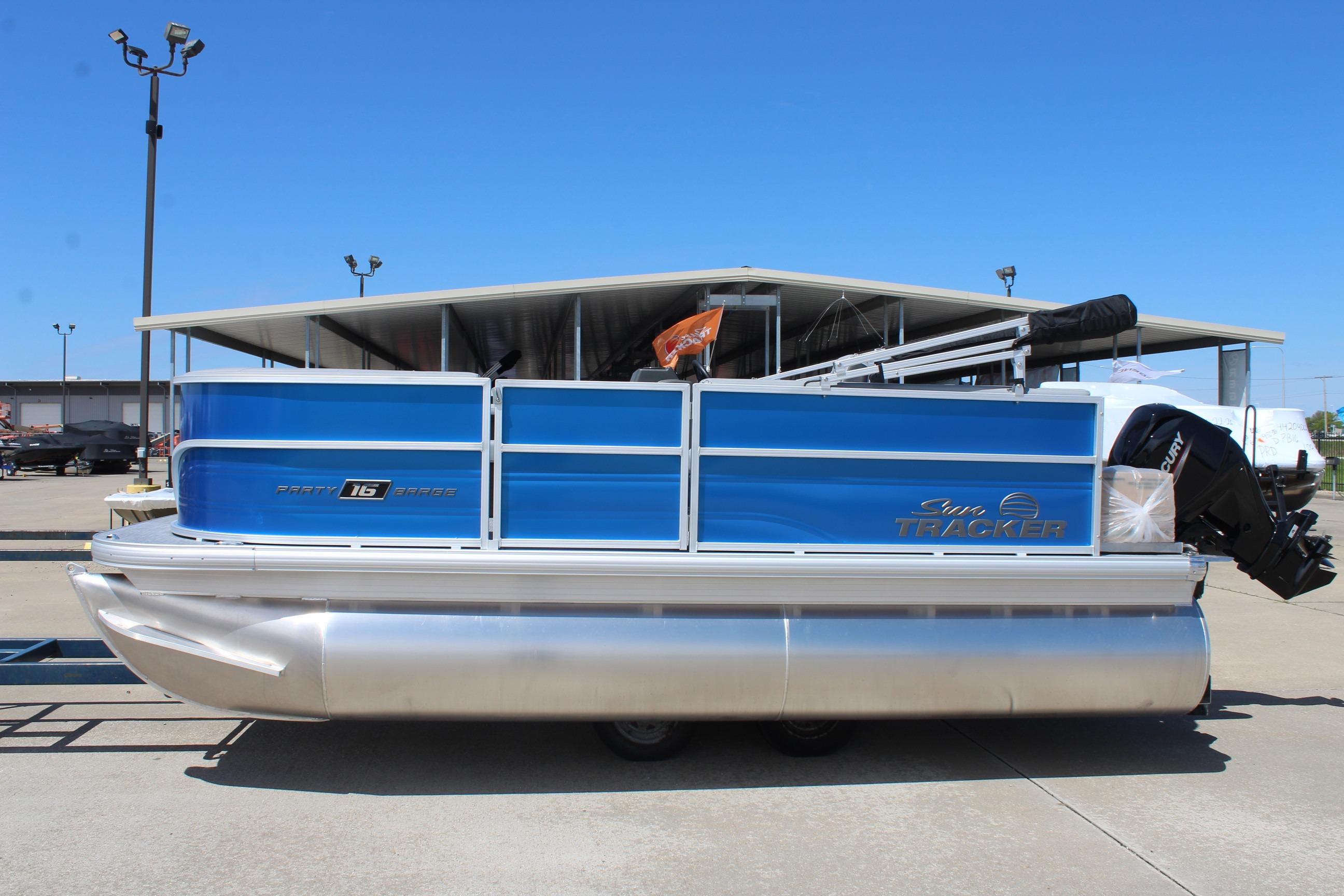 2026 Sun Tracker Party Barge 16 DLX pontoon boat in a marina setting.