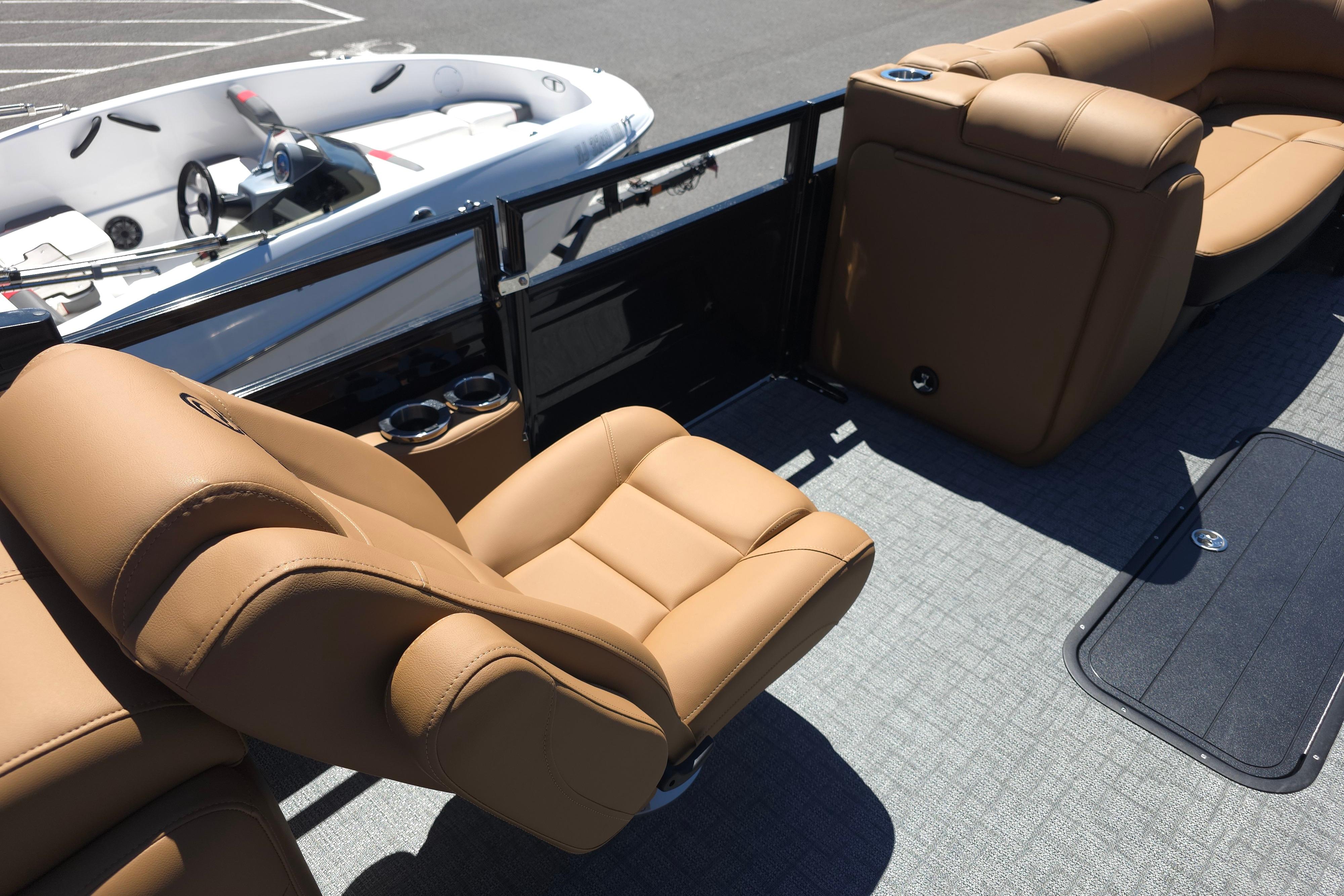 Luxurious seating on 2026 Regency 230 DL boat with tan leather upholstery.