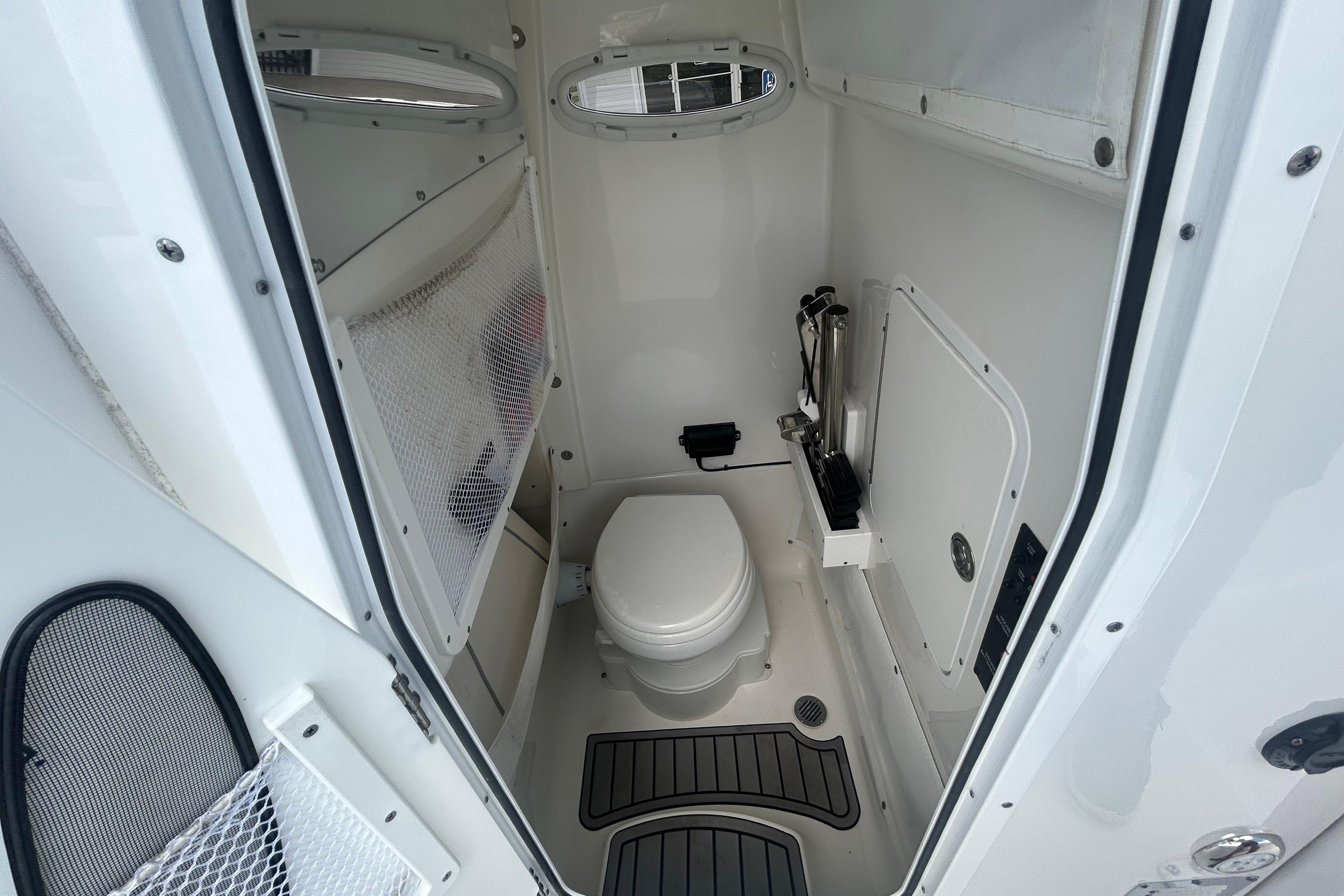 2023 Sea Hunt Gamefish 27 Coffin Box boat interior with compact marine toilet.
