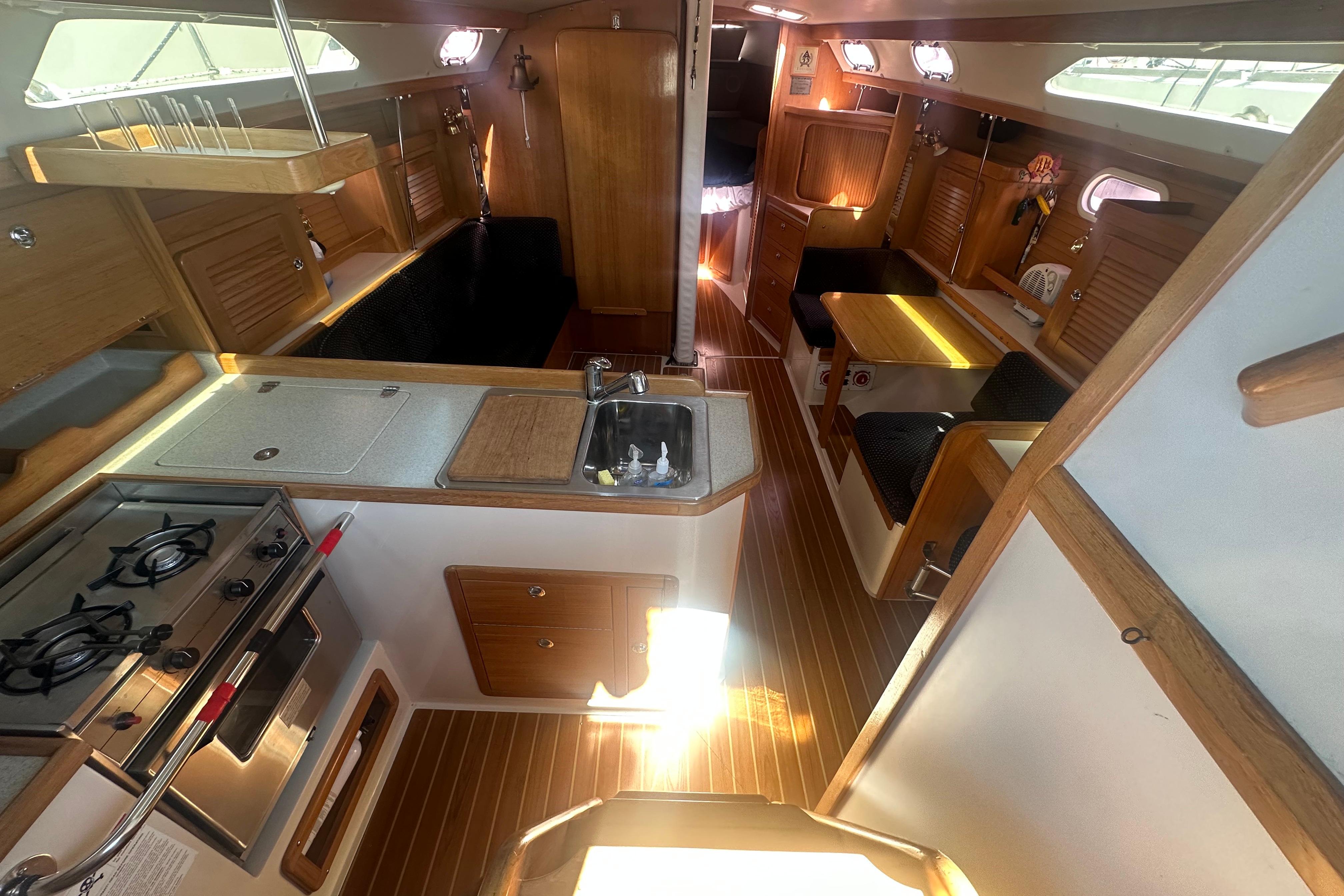 Interior of 2005 Catalina 36 MkII sailboat with kitchen, dining area, and wooden finishes.