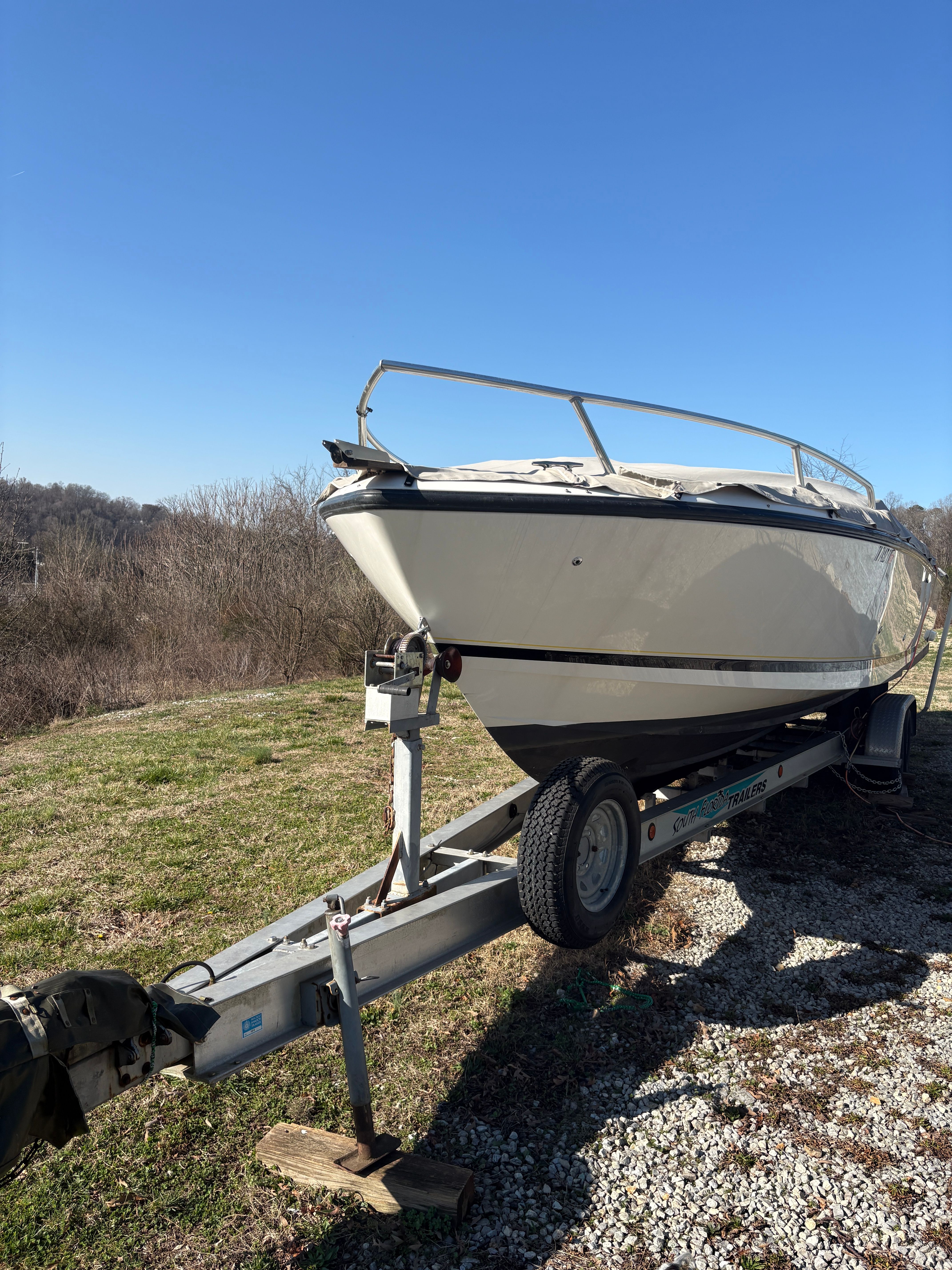 Intrepid 322 Cuddy Center Console boat on trailer, 2002 model.