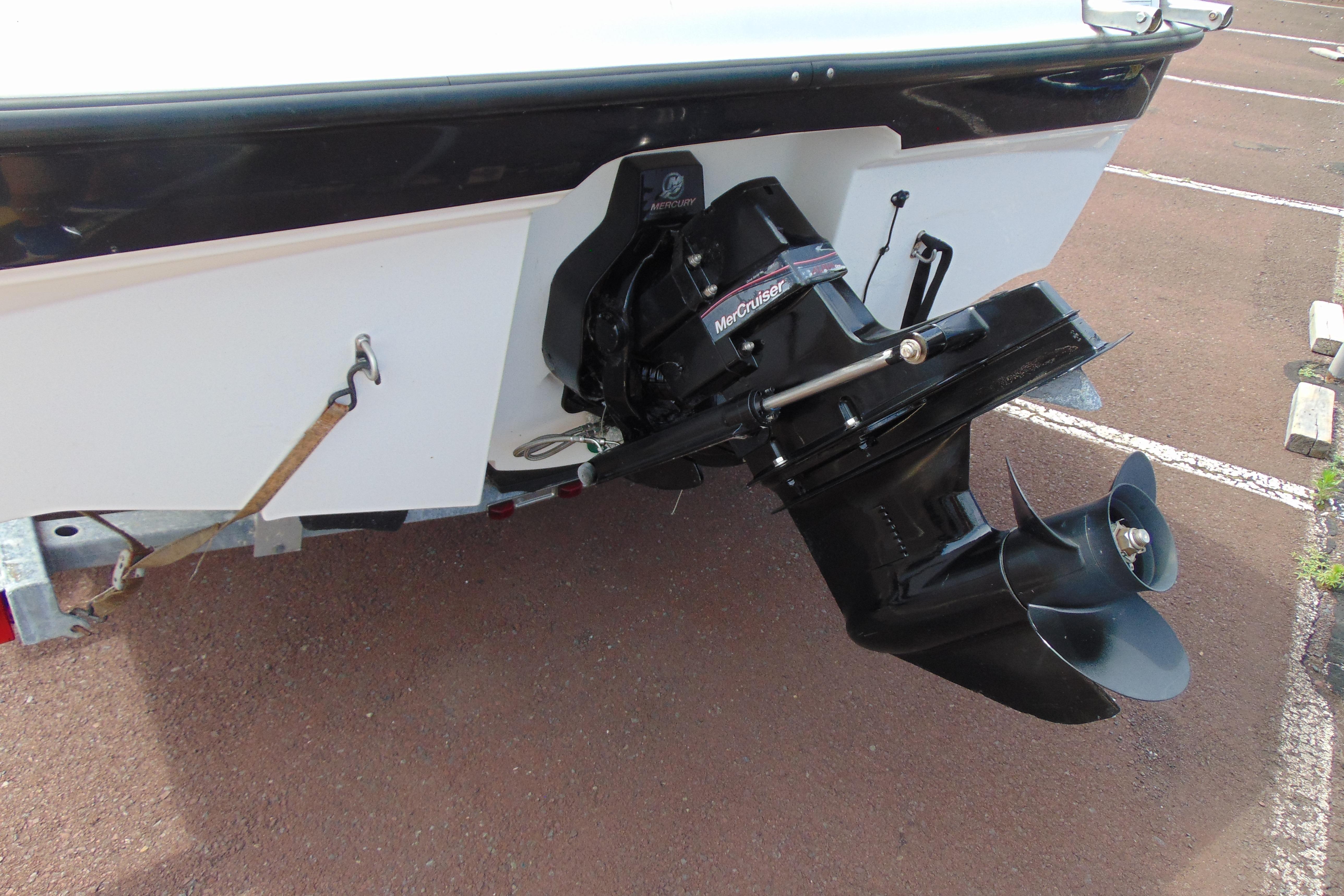 2012 Bayliner 185 Bowrider boat with MerCruiser outboard motor in a parking lot.