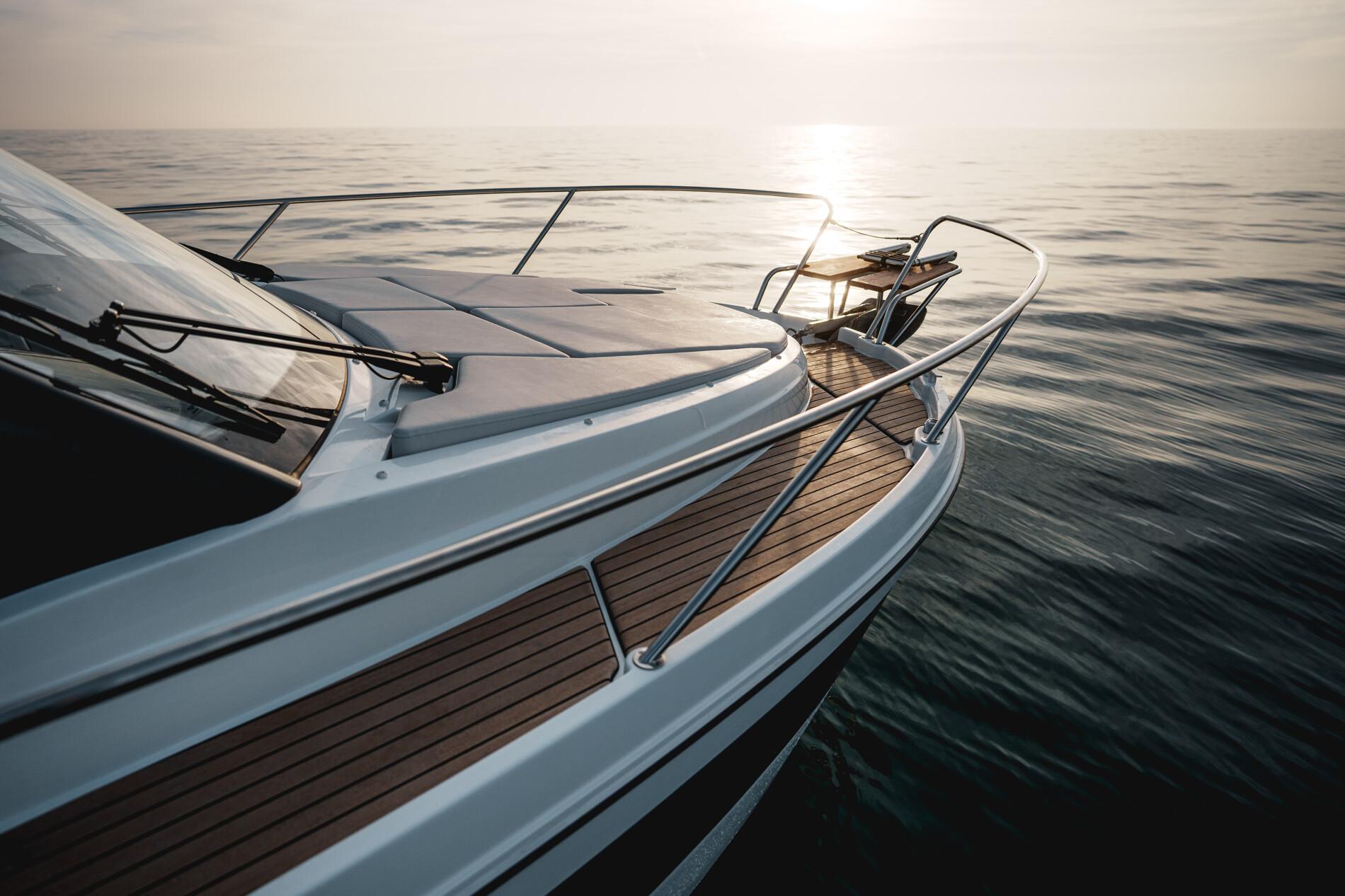 2025 Beneteau Antares 9 yacht on calm sea at sunset.