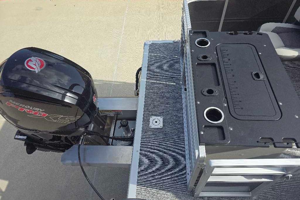 2026 Sun Tracker Fishin' Barge 20 DLX with Mercury outboard motor and fishing station.