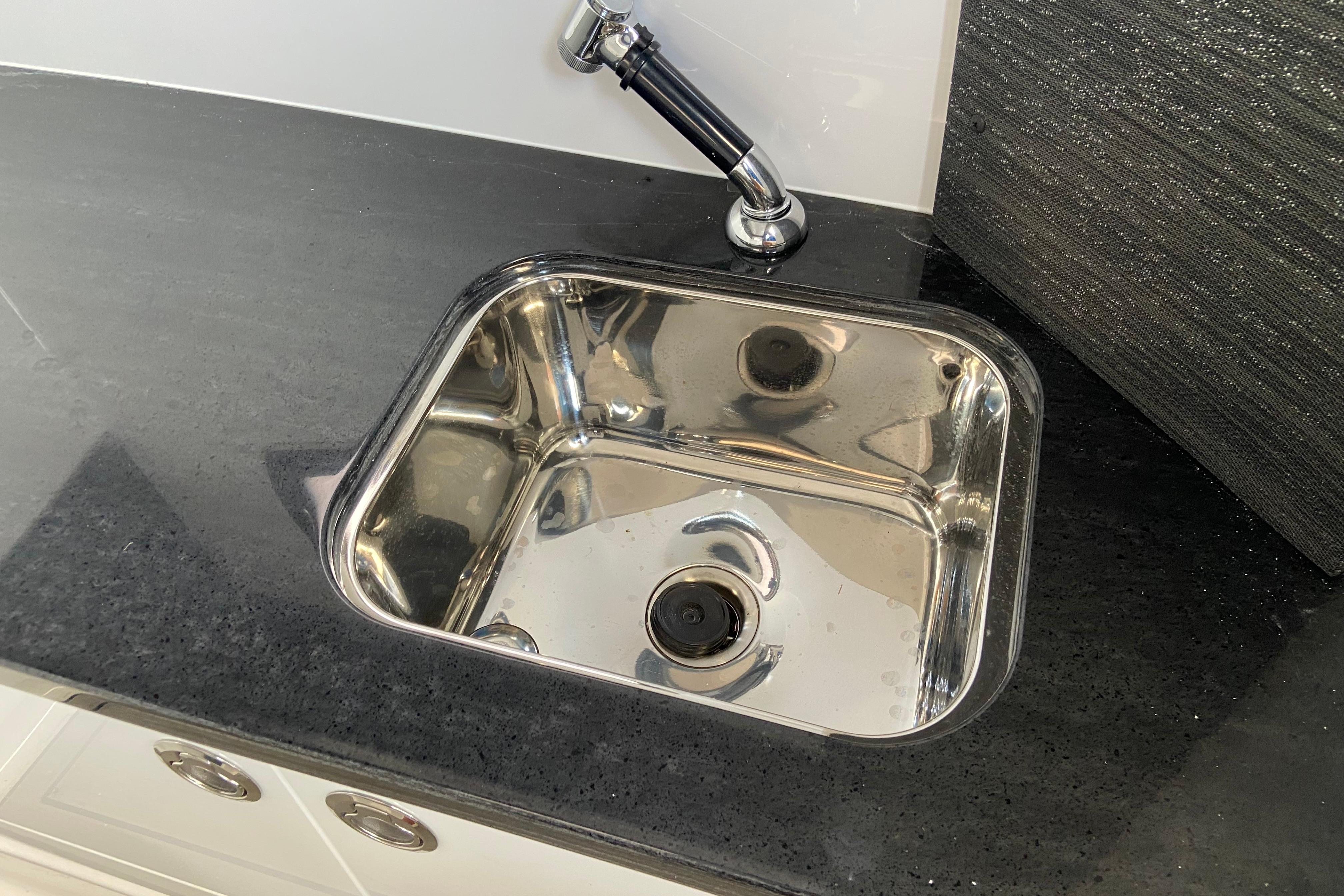 Stainless steel sink on Monterey Elite 30 OB, 2026 model, with sleek black countertop.