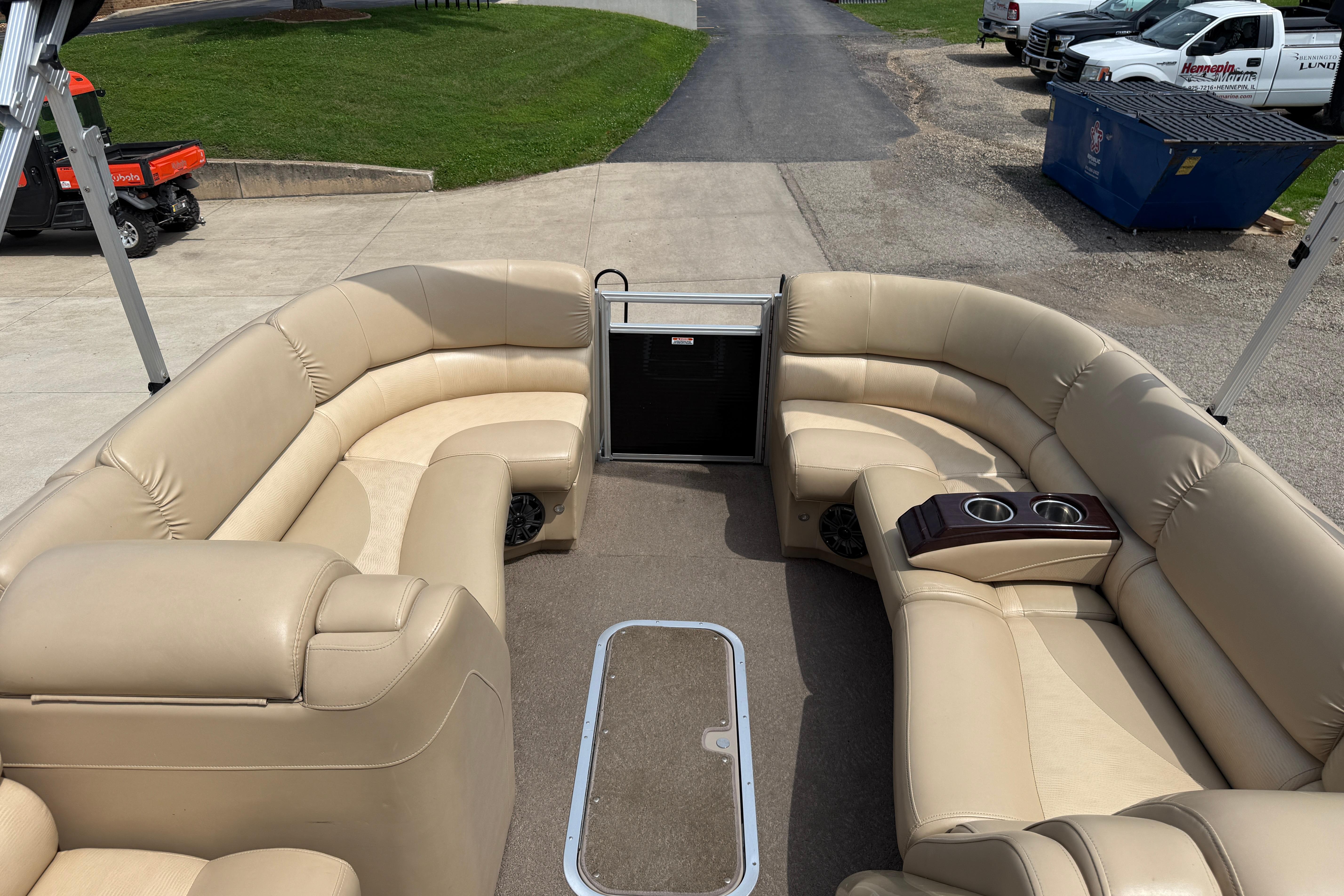 Luxurious seating on a 2011 Bennington 2575QCW I/O pontoon boat, featuring beige upholstery.