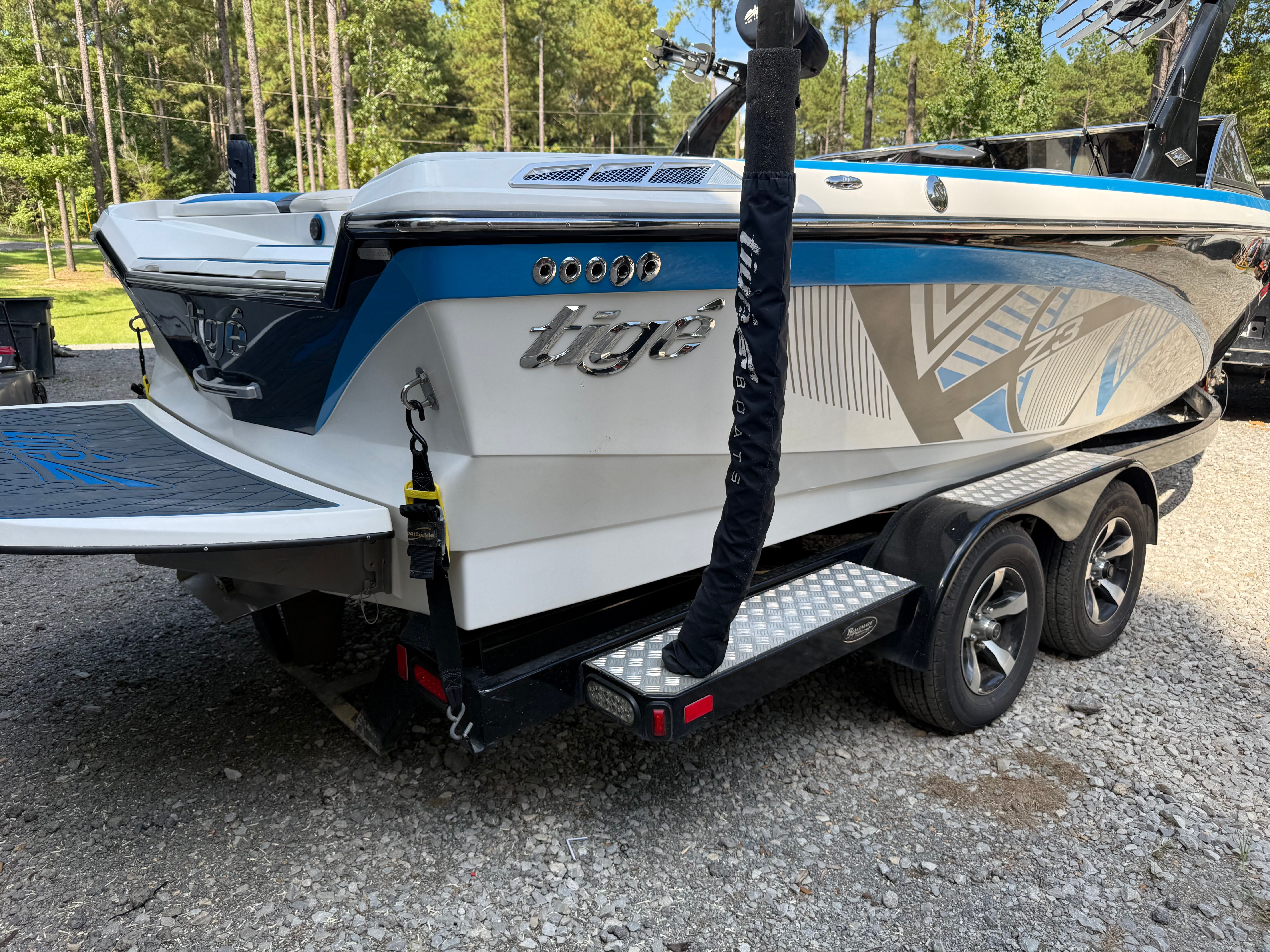 Custom Z3 boat from 2012 on trailer outdoors.