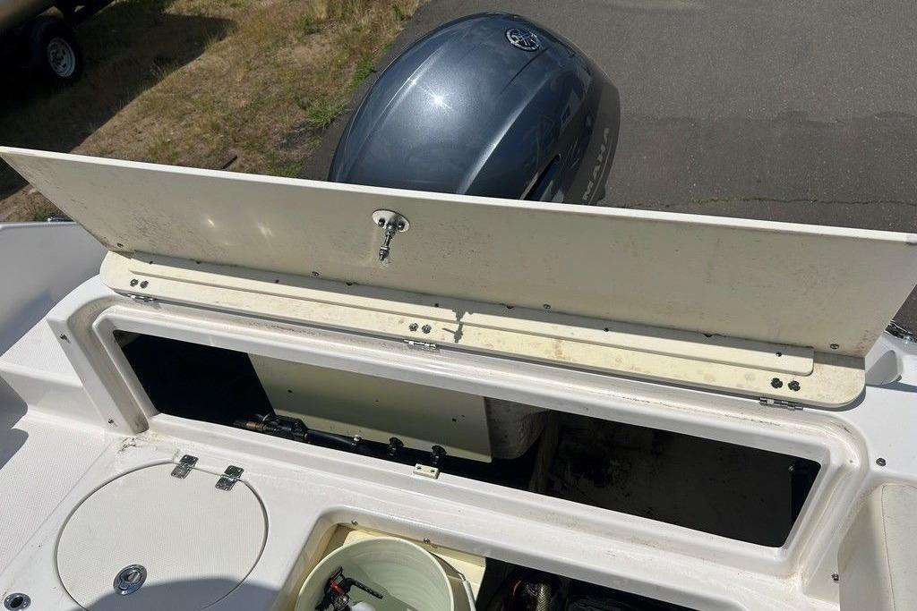 2017 Robalo R200ES boat storage compartment with open lid and visible engine.