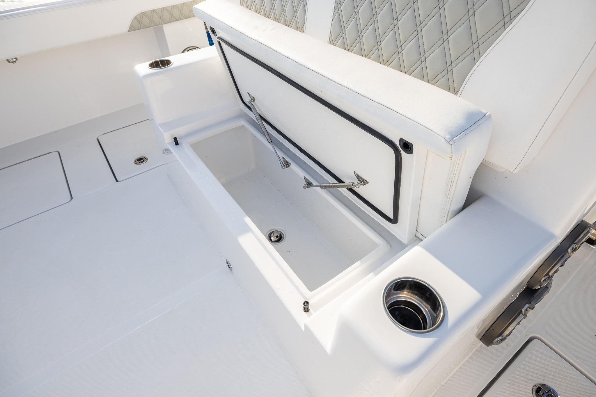 Interior view of 2026 Front Runner 37 Catamaran, featuring a storage compartment and cup holders.