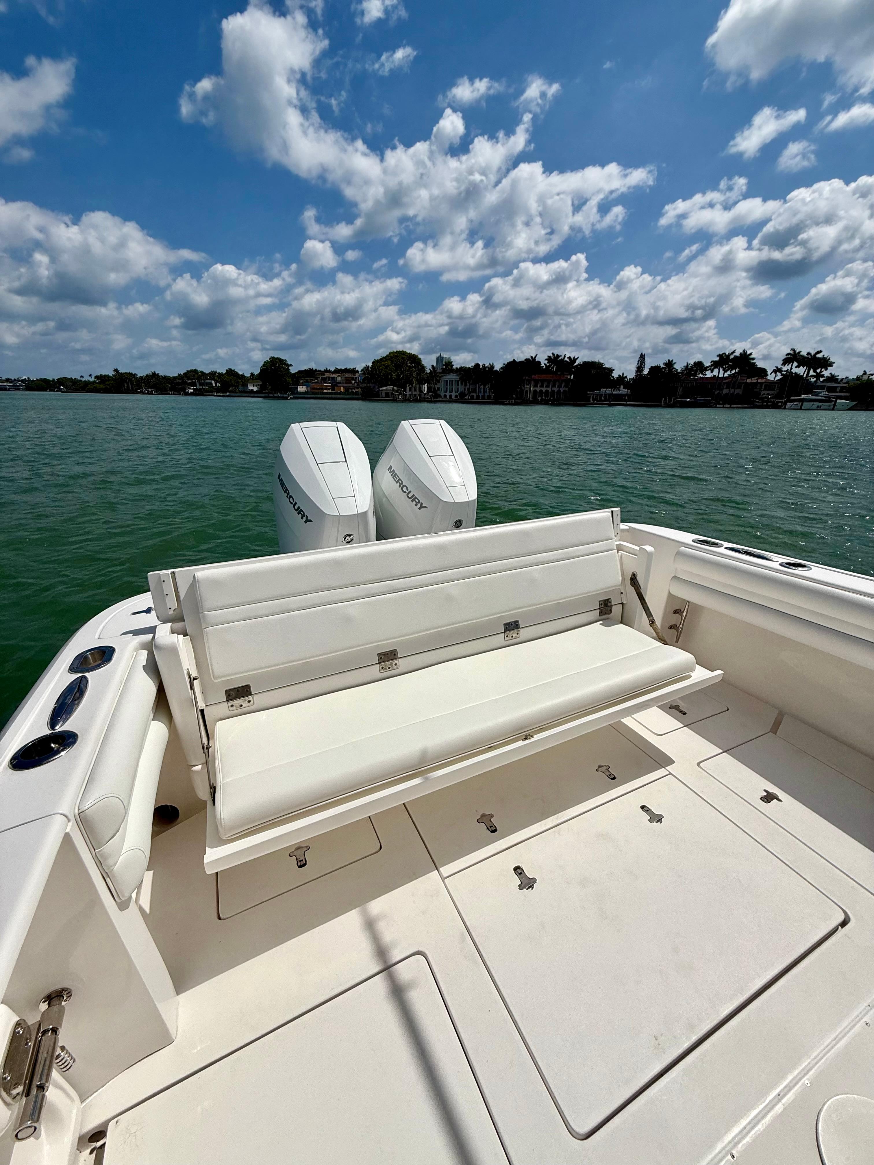 2015 Intrepid 375 Center Console boat with dual engines on a sunny day.