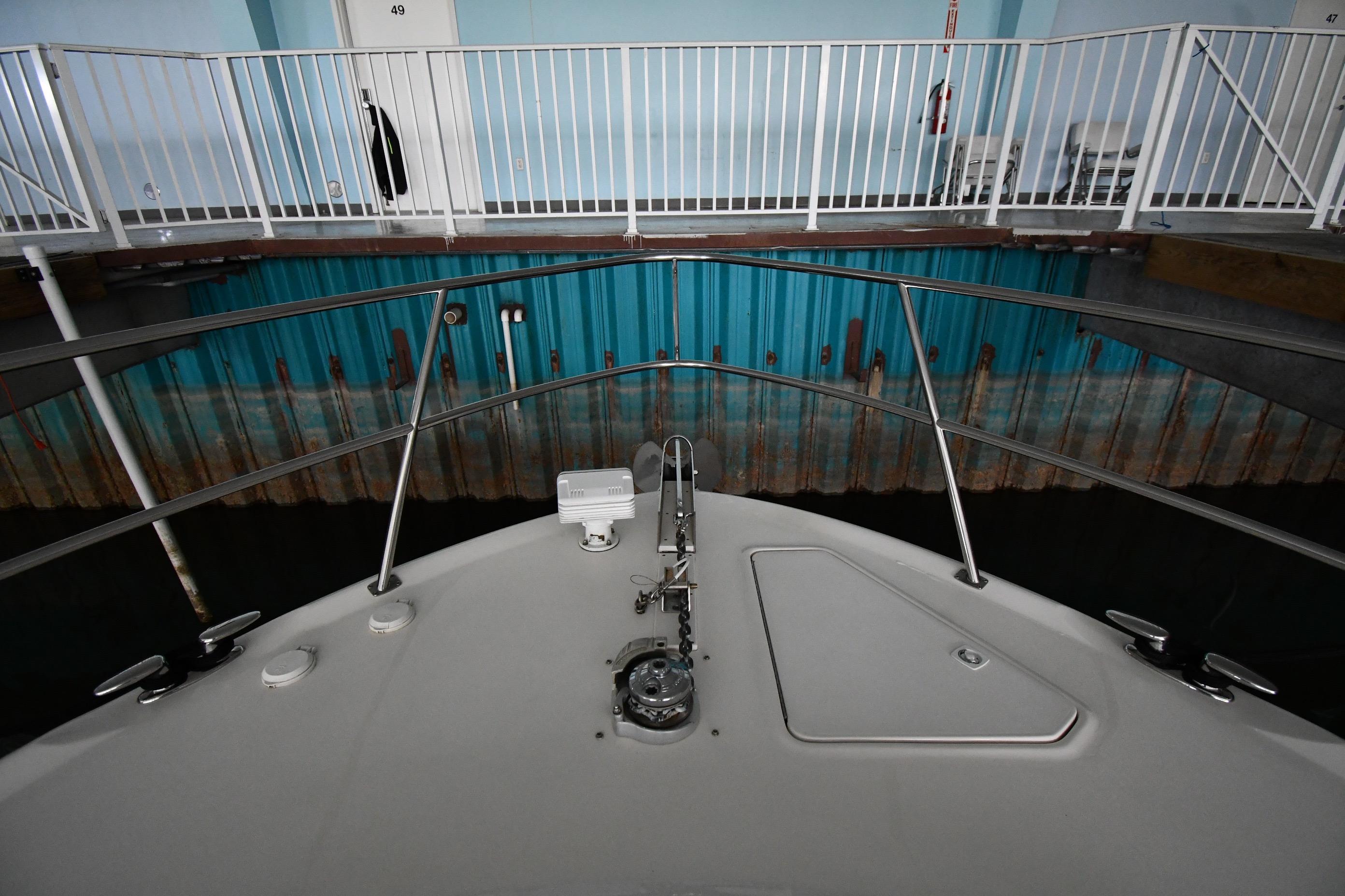 Bow view of 2001 Sea Ray 540 Sundancer docked indoors.