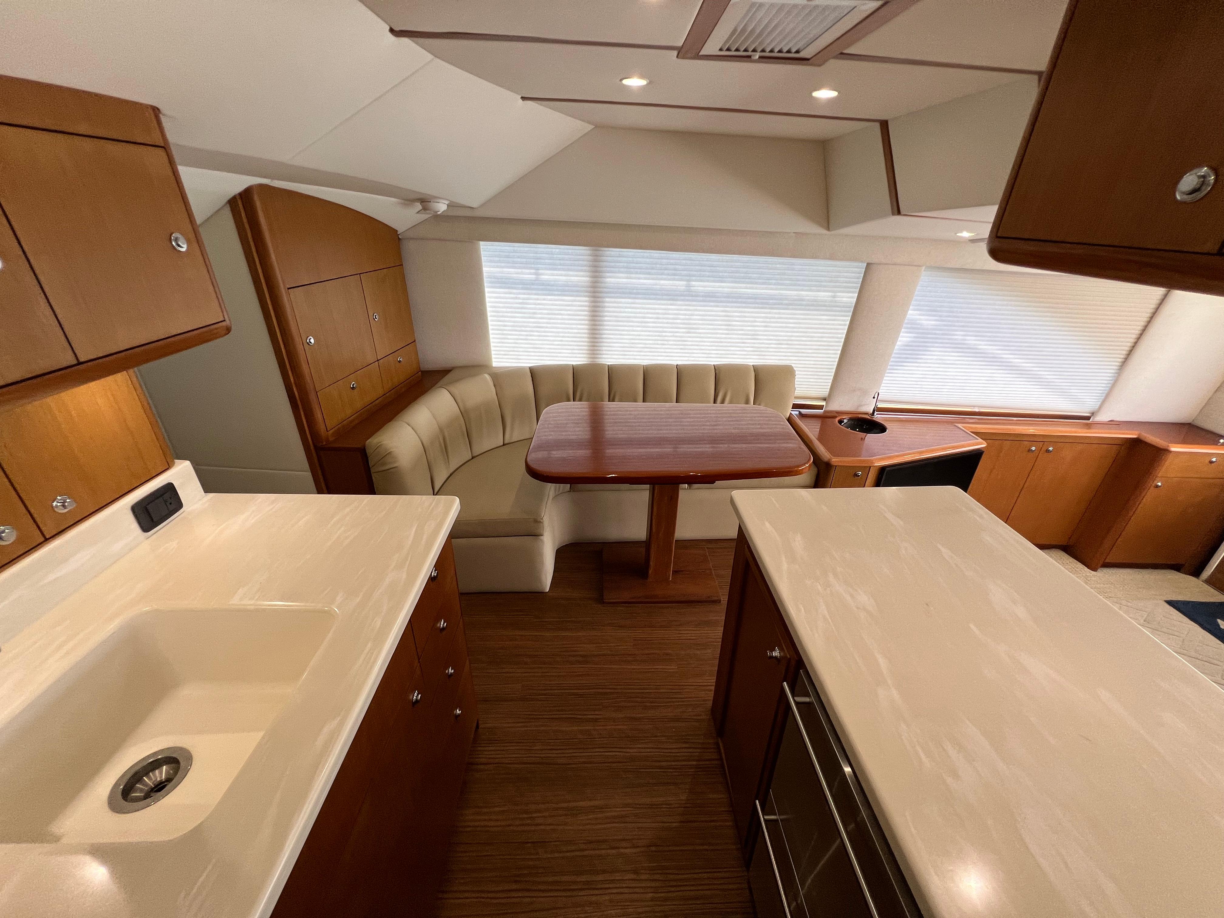 Interior of 2001 Ocean 52 Convertible yacht with kitchen and dining area.