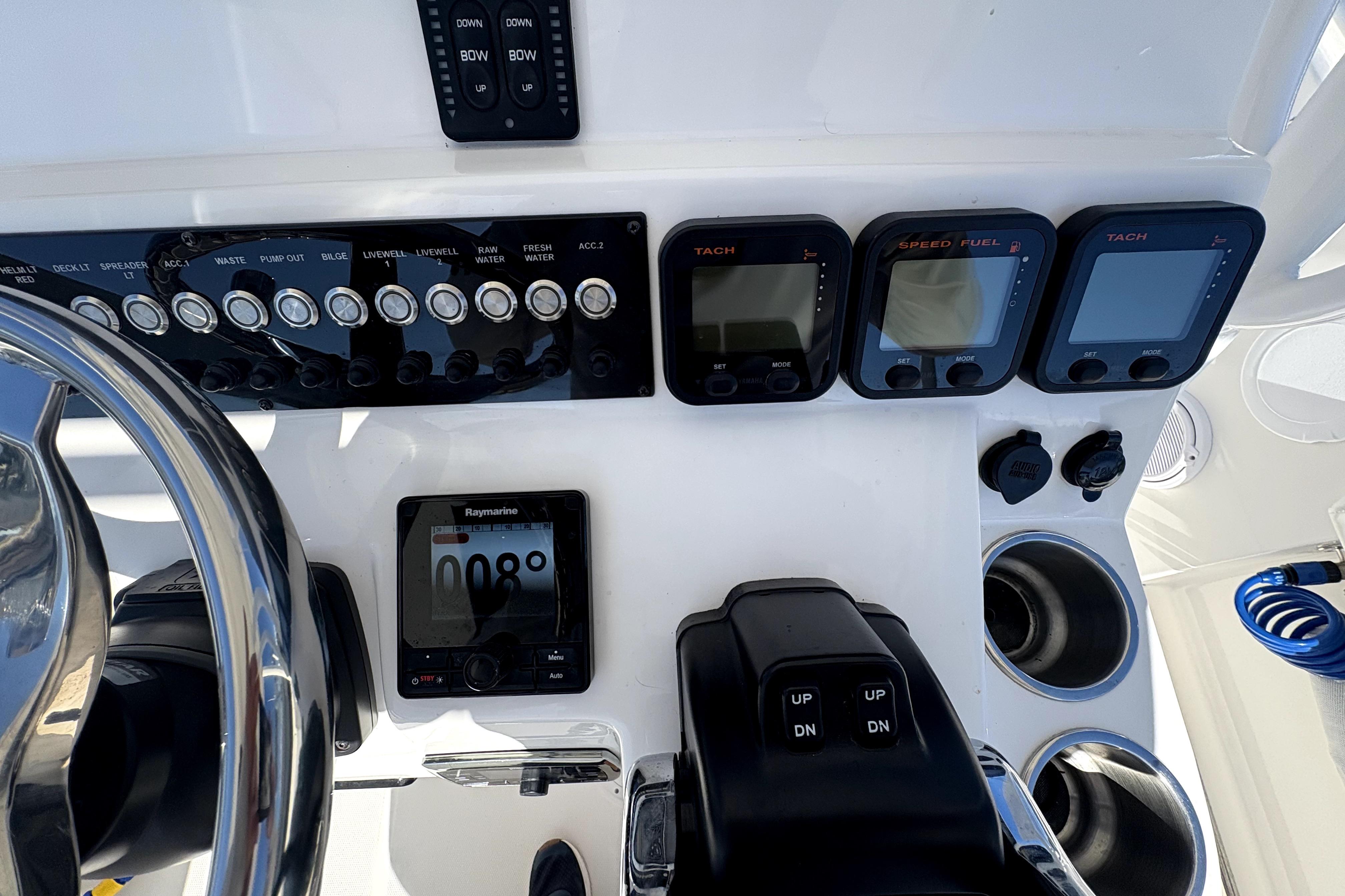 Control panel of a 2015 Edgewater 245CC boat with gauges and switches.