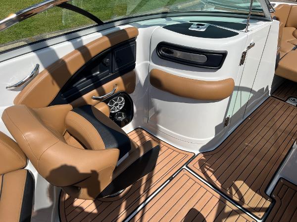 2024 Crownline Eclipse E255 boat interior with tan seating and wood-style flooring.