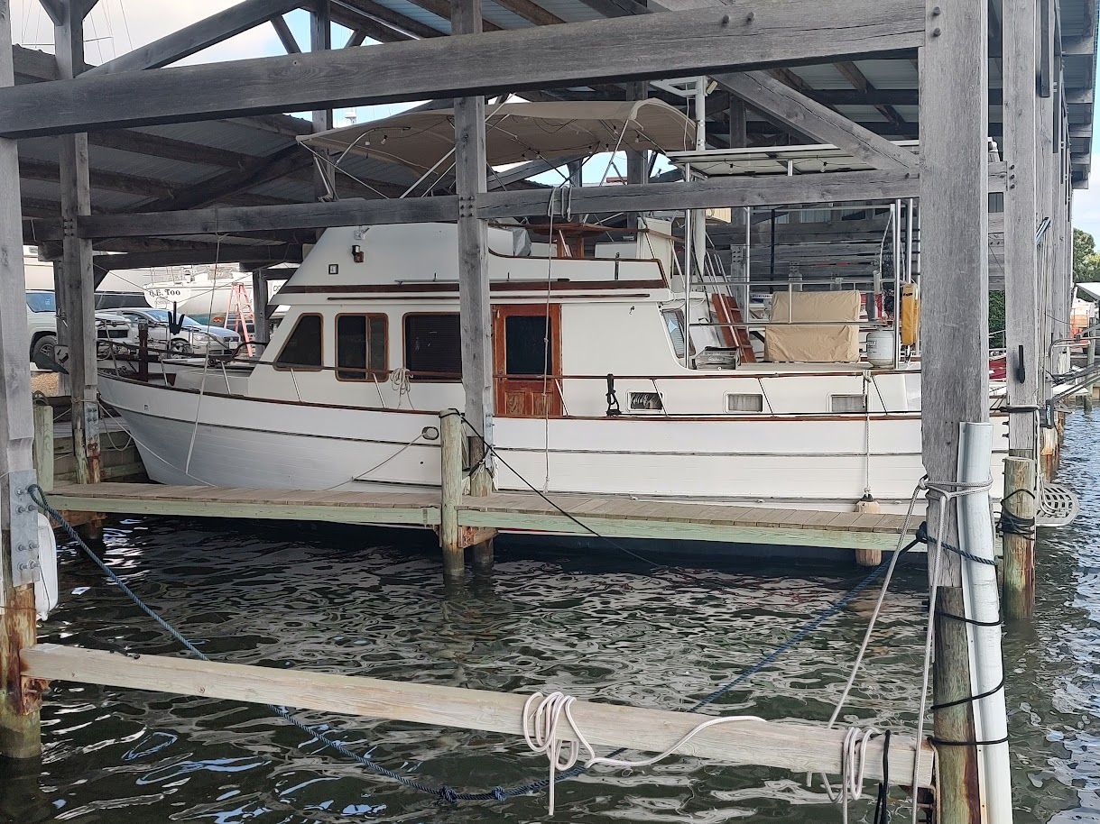 1983 Marine Trader Double Cabin 40 docked in marina.