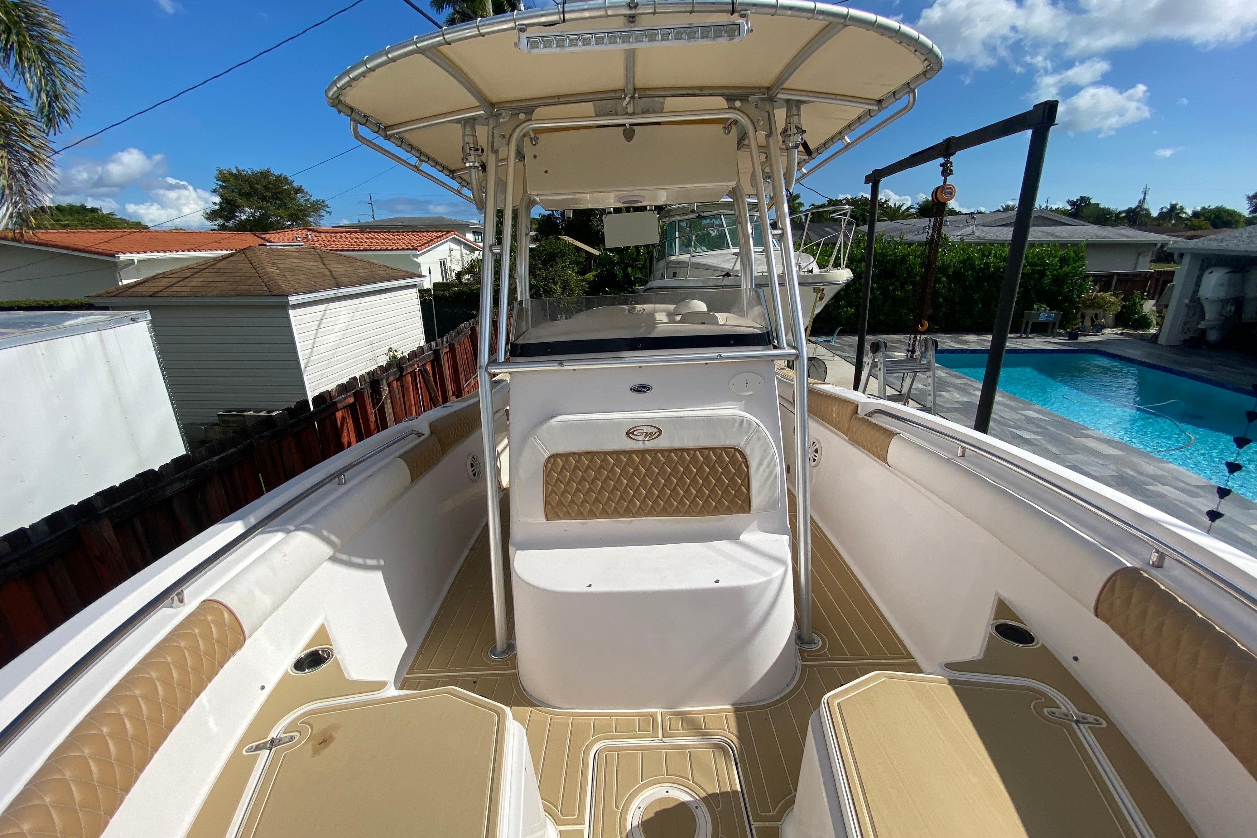 2004 Grady-White Canyon 283 boat with spacious deck and seating, near a poolside.