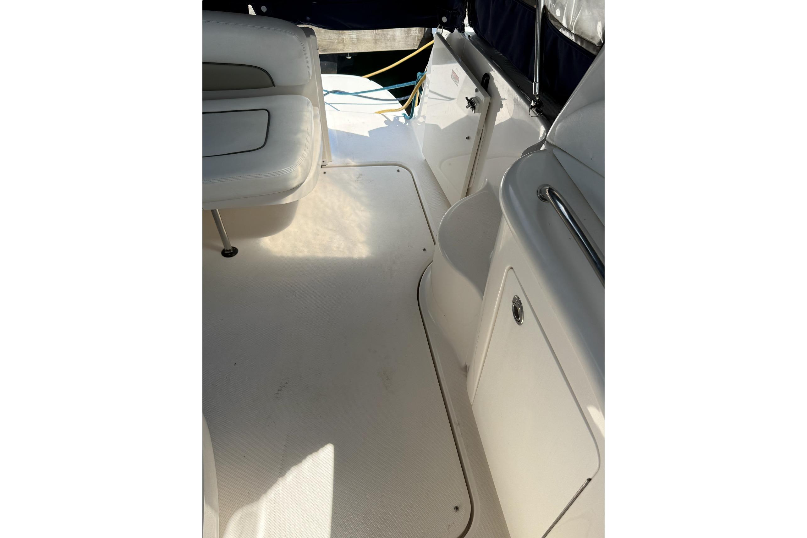 Interior view of a 2006 Sea Ray 300 Sundancer boat, featuring seating and storage compartments.