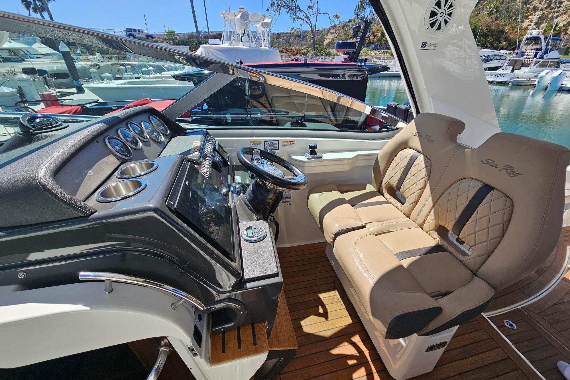 2016 Sea Ray Sundancer 350 helm with luxurious seating and modern dashboard controls.