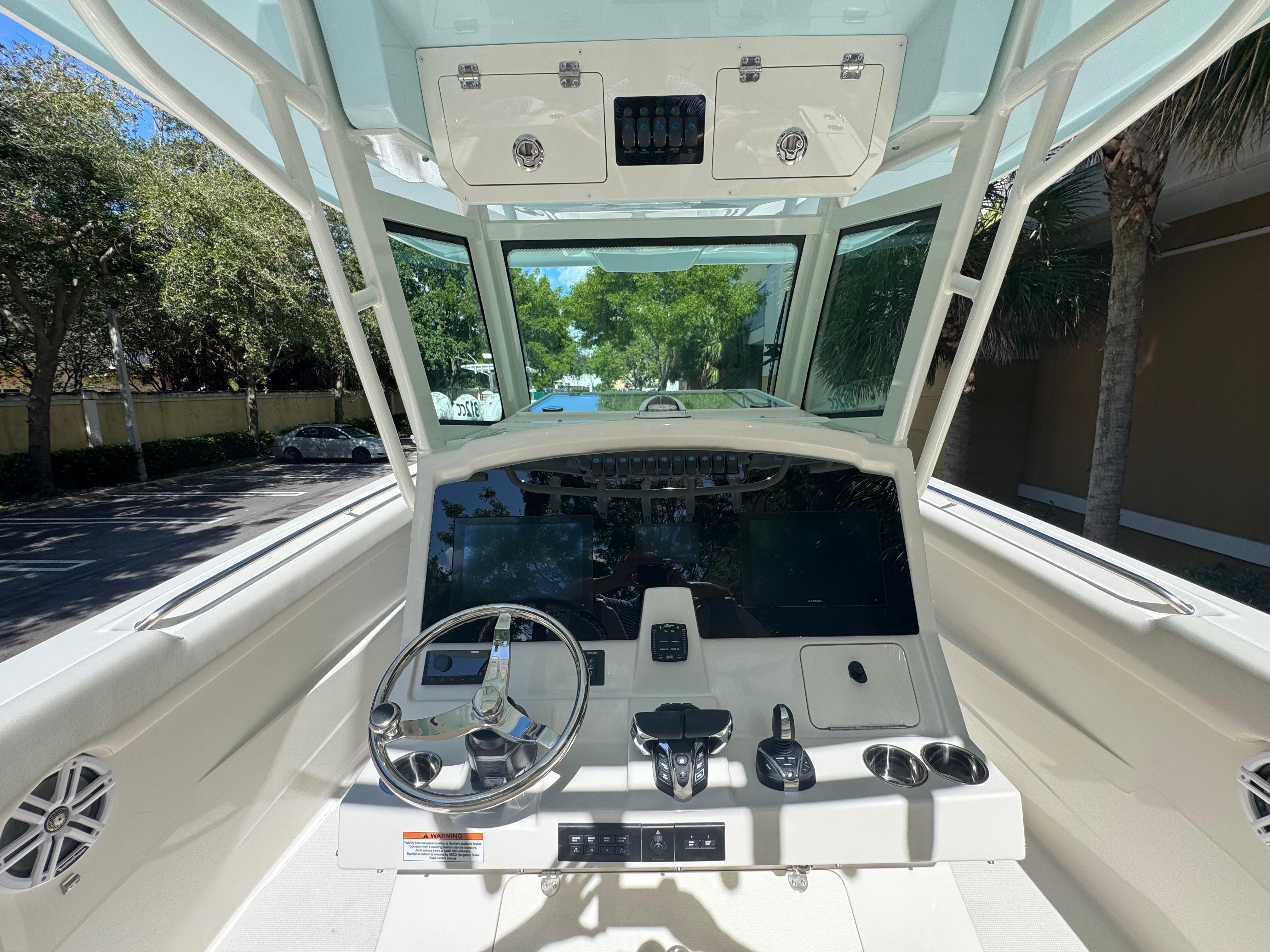 2026 Sailfish 312 CC boat cockpit with steering wheel and control panel.
