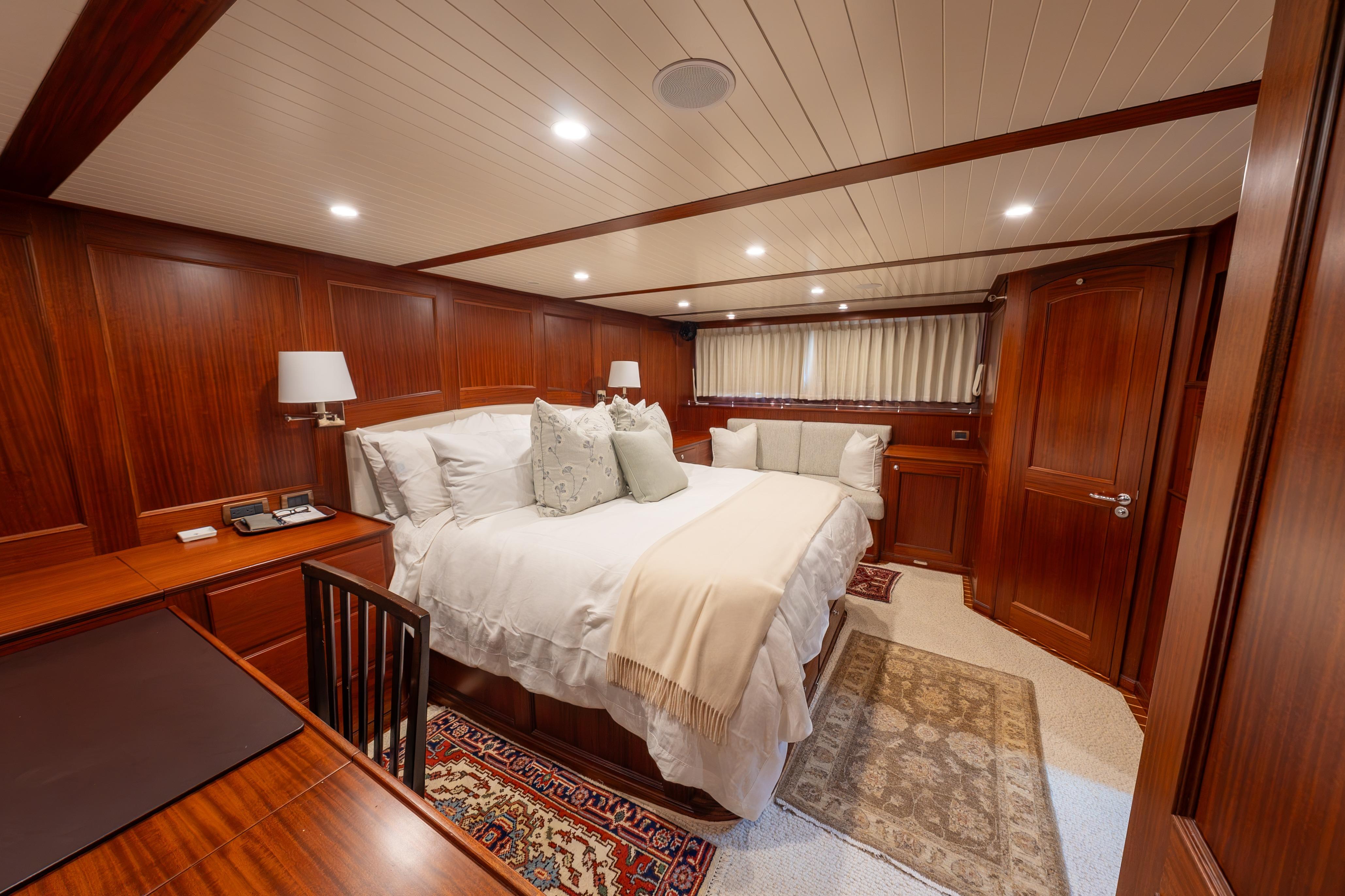 Luxurious cabin interior of 2022 Hunt Yachts Ocean 76EP with elegant wood paneling.