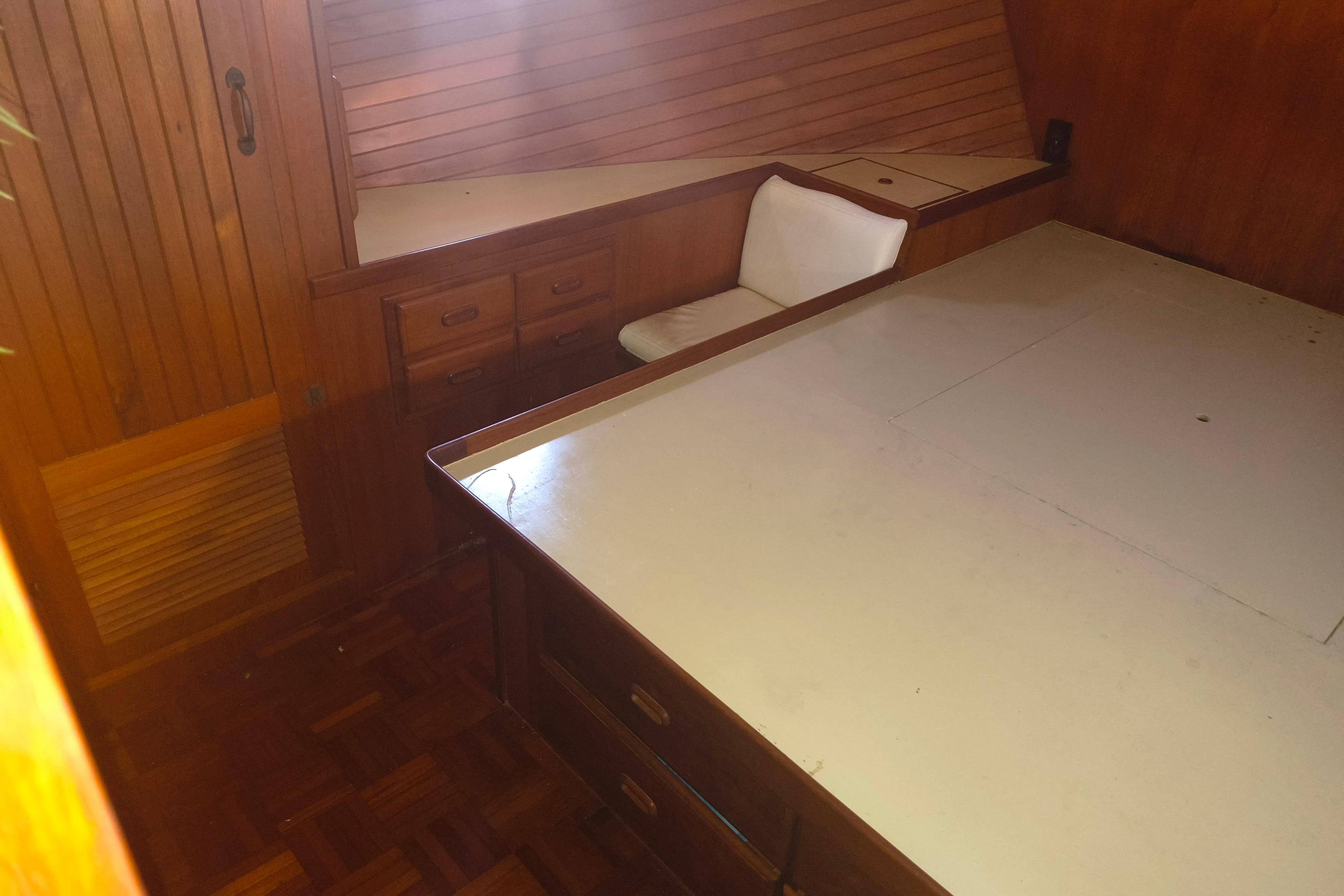 1984 Kadey-Krogen Manatee interior with wooden cabinetry and seating area.