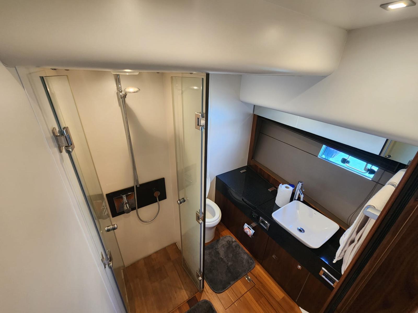 Luxurious bathroom in 2012 Fairline Squadron 65 yacht with modern shower and sleek vanity.
