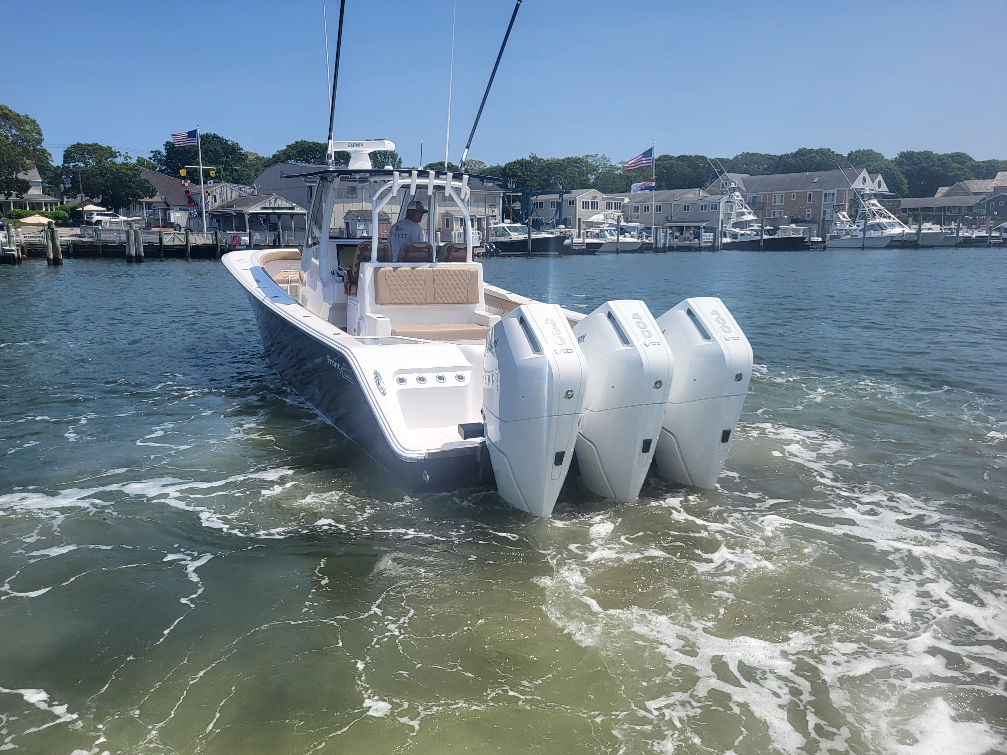 2025 Front Runner 39 boat with triple engines in a marina setting.