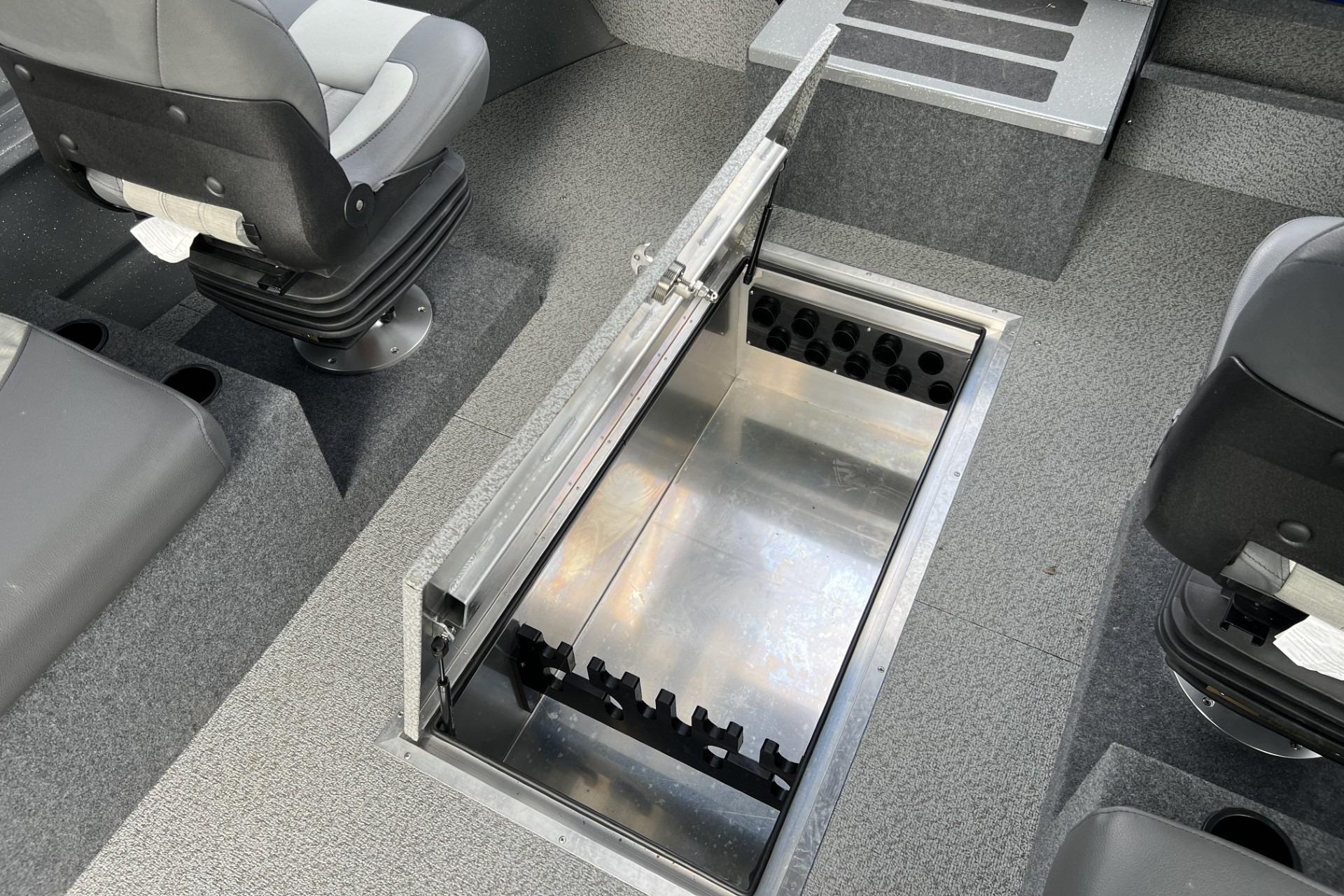 2024 Spartan 26 Maximus Pro XL boat interior with open storage compartment and seating.