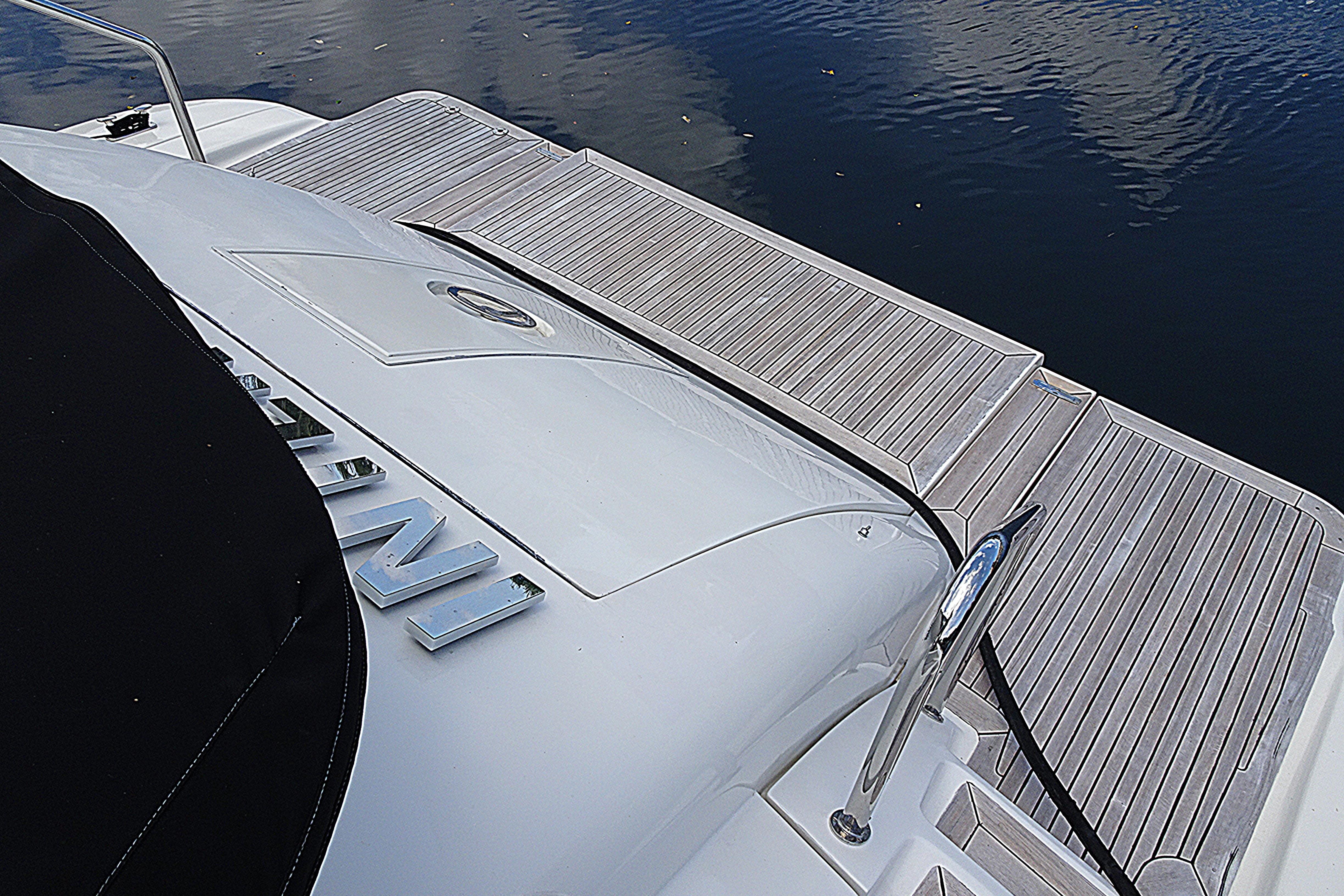 Azimut 100 Leonardo 2010 yacht deck with sleek design and water reflection.
