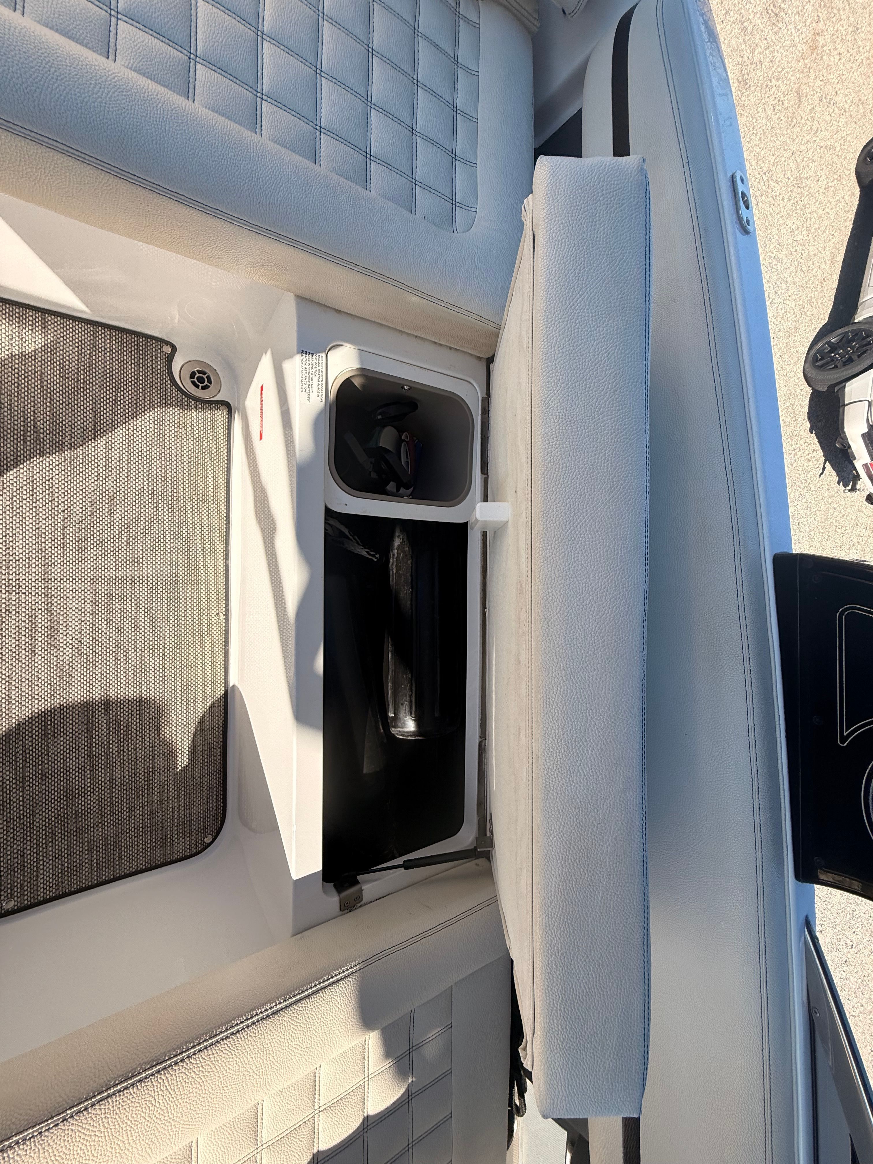 The image shows the interior of a 2019 Cobalt R7 Surf boat with an open storage compartment.