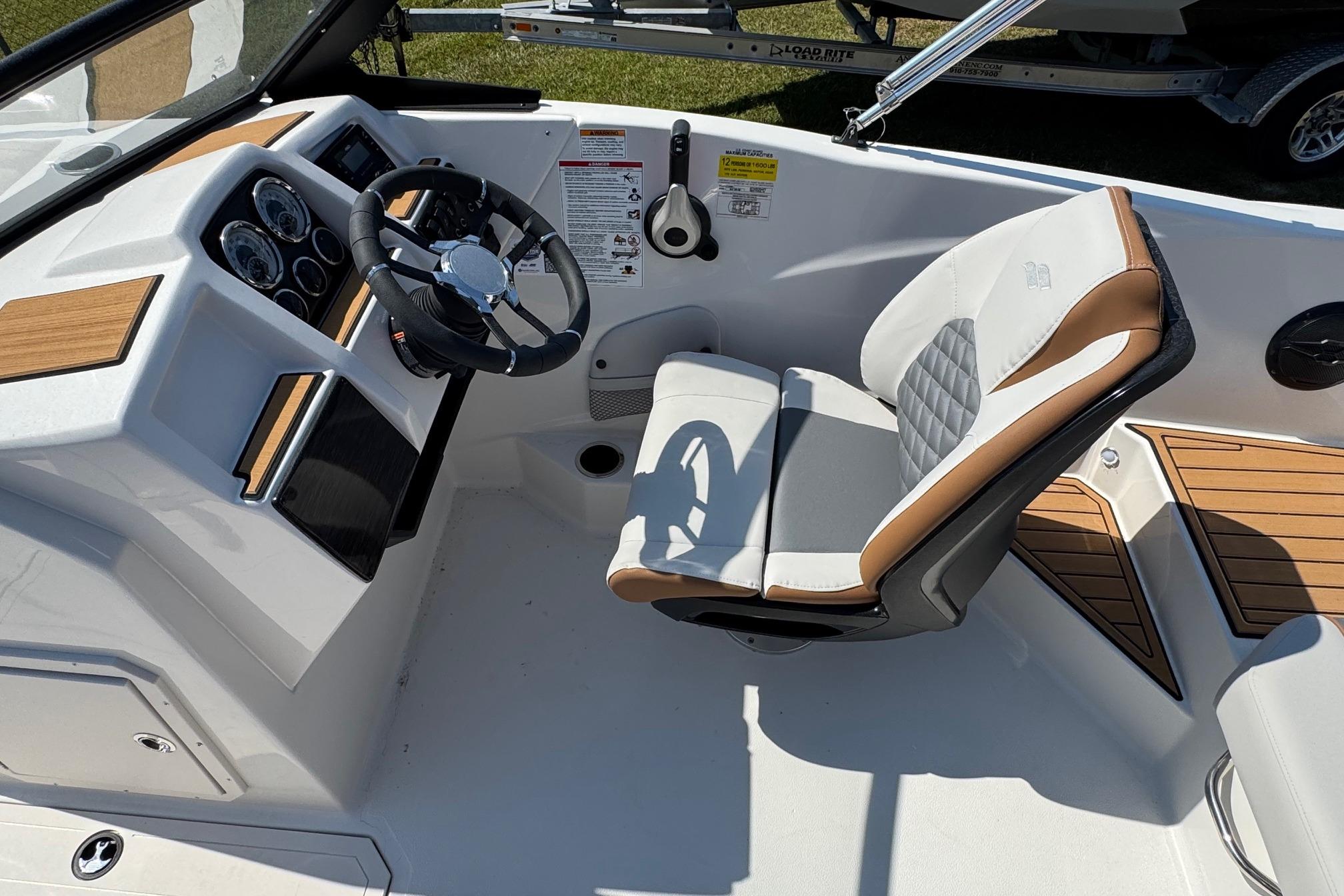 2026 Starcraft SVX 190 OB boat interior with steering wheel and cushioned seat.