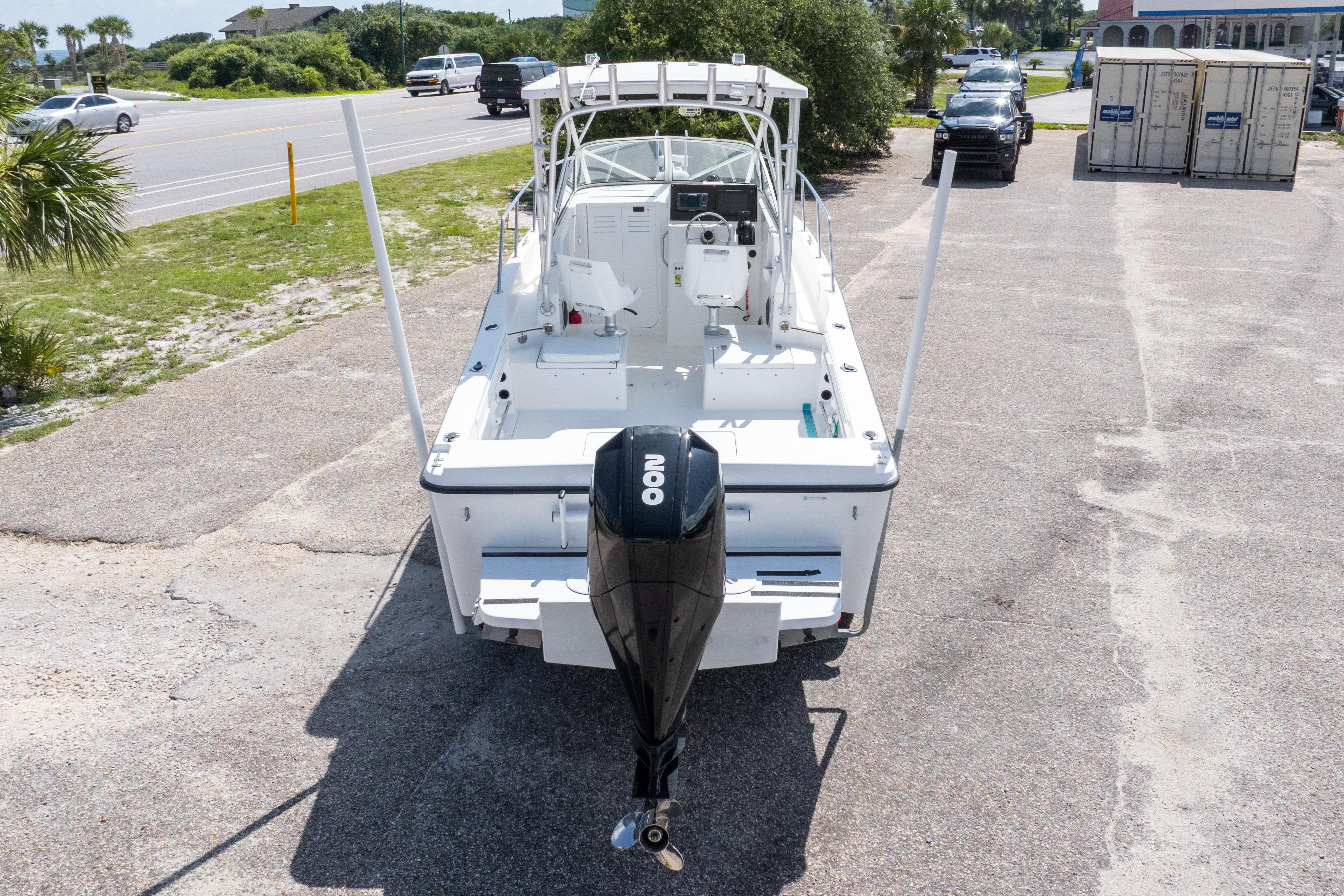 2007 Sea Boss 235 Walkaround boat with outboard motor, parked on a sunny day.