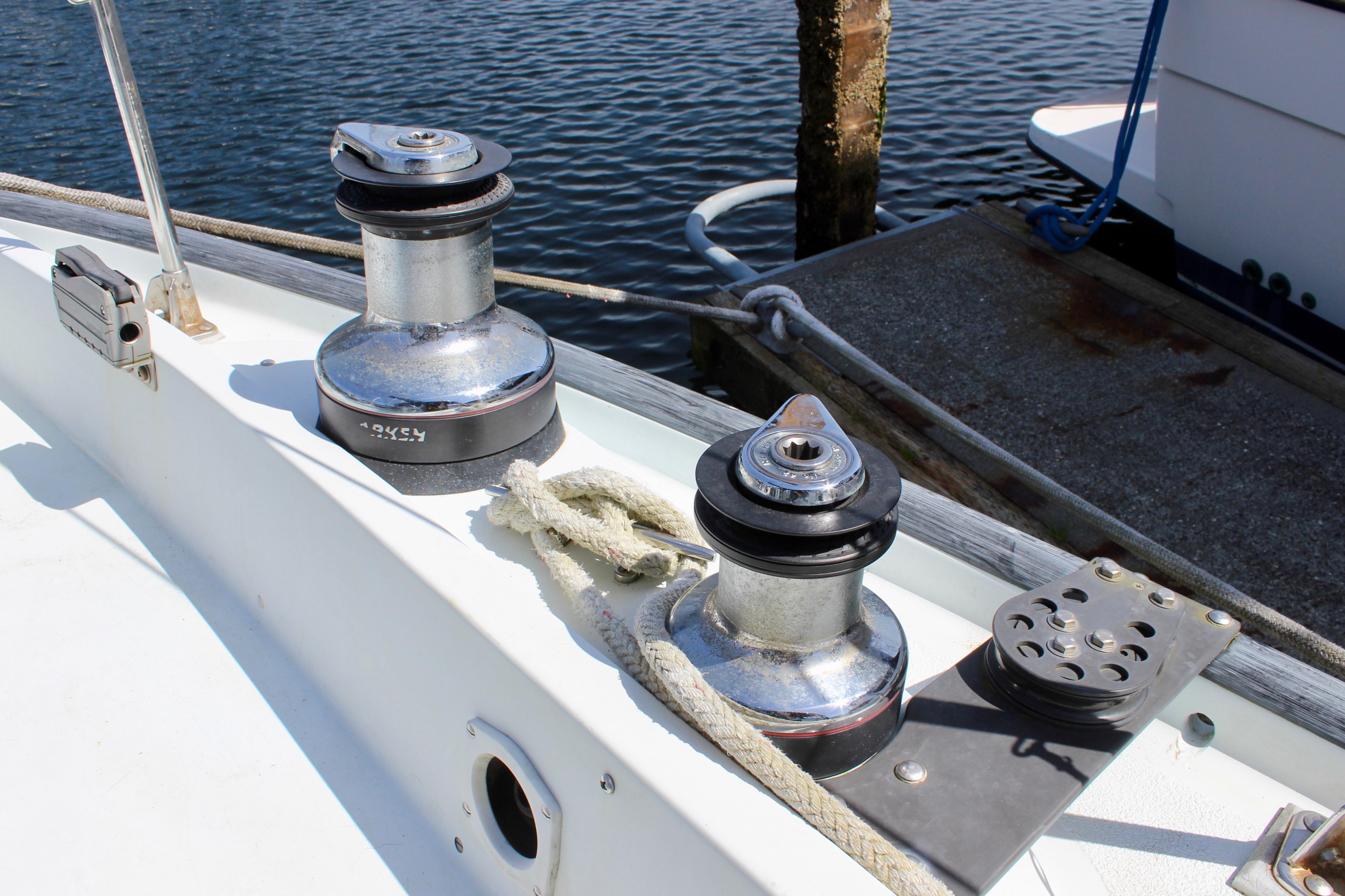 Sailboat deck with winches and ropes, Freya 39 model, 1993, docked by water.